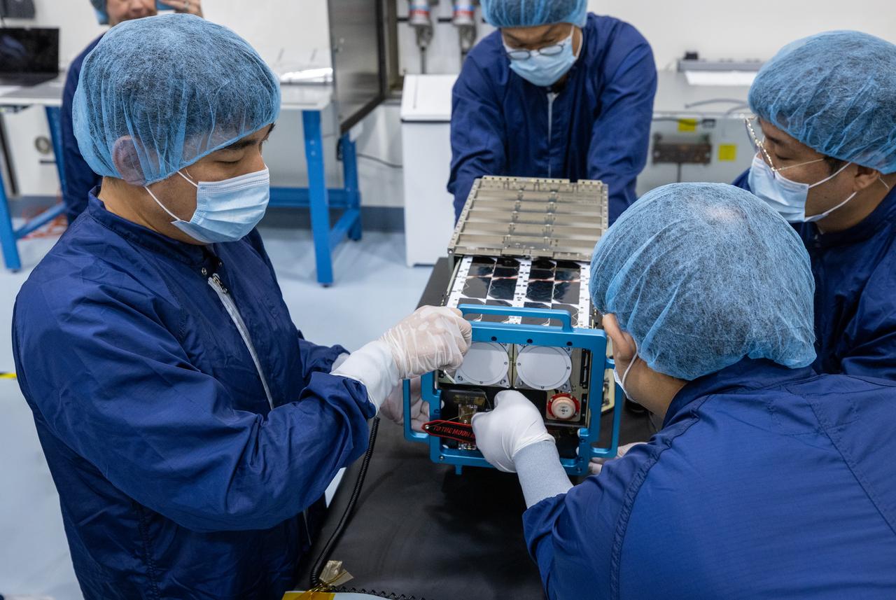 Inside the Multi-Payload Processing Facility at NASA’s Kennedy Space Center in Florida, on Wednesday, Aug. 27, 2025, technicians with the Korea AeroSpace Administration (KASA) complete closeouts on the K-Rad Cube, one of several international CubeSats slated to fly on NASA’s Artemis II test flight in 2026. Deploying in high Earth orbit from a spacecraft adapter on NASA’s SLS (Space Launch System) rocket after Orion is safely flying on its own with its crew of four astronauts, K-Rad Cube will use a dosimeter made of material designed to mimic human tissue to measure space radiation and assess biological effects at various altitudes across the Van Allen radiation belts, a critical area of research for human presence at the Moon and Mars.