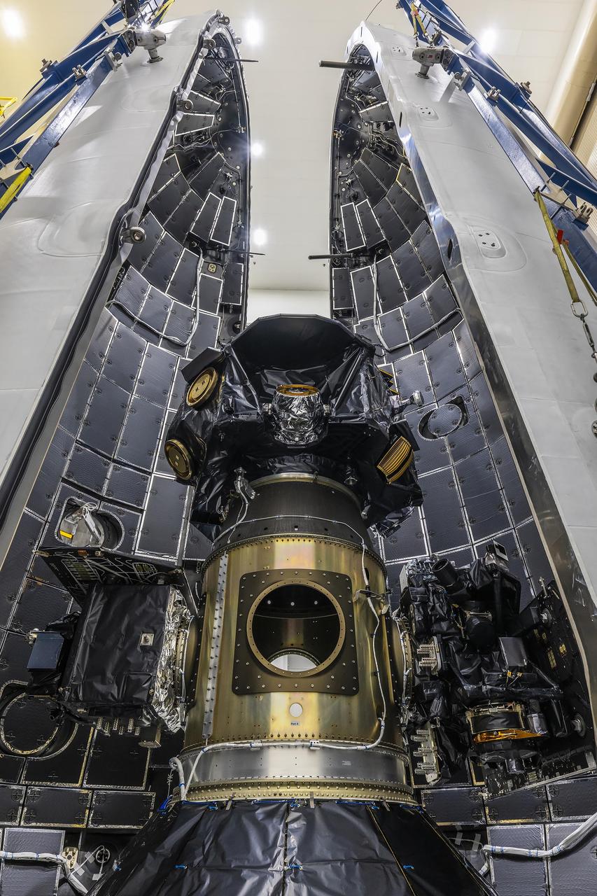 Technicians at Astrotech Space Operations Facility near NASA’s Kennedy Space Center in Florida encapsulate NASA’s IMAP (Interstellar Mapping and Acceleration Probe) spacecraft on Tuesday, Sept. 16, 2025, inside SpaceX’s Falcon 9 payload fairings to protect the spacecraft during launch. NASA’s IMAP will use 10 science instruments to study and map the heliosphere, a vast magnetic bubble surrounding the Sun protecting our solar system from radiation incoming from interstellar space. This mission and its two rideshares – NASA’s exosphere-studying Carruthers Geocorona Observatory and National Oceanic and Atmospheric Administration’s (NOAA) Space Weather Follow On–Lagrange 1 (SWFO-L1) observatory – will orbit the Sun near Lagrange point 1, about one million miles from Earth, where it will scan the heliosphere, analyze the composition of charged particles, and investigate how those particles move through the solar system. Launch is targeted for no earlier than Tuesday, Sept. 23, 2025, from Launch Complex 39A at NASA Kennedy.