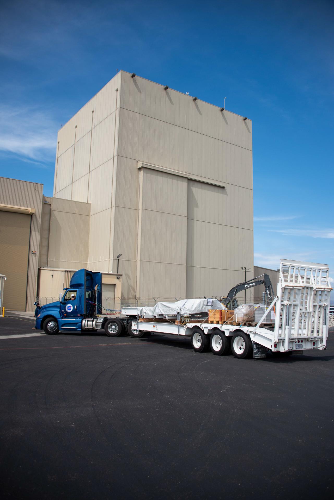 Packed in its shipping container, the Sentinel-6B spacecraft, a collaboration between NASA, ESA (European Space Agency), EUMETSAT (European Organisation for the Exploitation of Meteorological Satellites), and the National Oceanic and Atmospheric Administration (NOAA), arrives by truck to the Astrotech Space Operations payload processing facility at Vandenberg Space Force Base in California on Wednesday, Sept. 17, 2025. The second of two spacecraft that constitutes the Sentinel-6/Jason-CS (Continuity of Service) mission, Sentinel-6B will measure sea surface height and provide crucial information to help improve coastal planning, enabling local and state governments to make informed decisions about protecting coastal infrastructure, real estate, and energy sites. Launch is targeted for no earlier than November on a SpaceX Falcon 9 from Vandenberg.