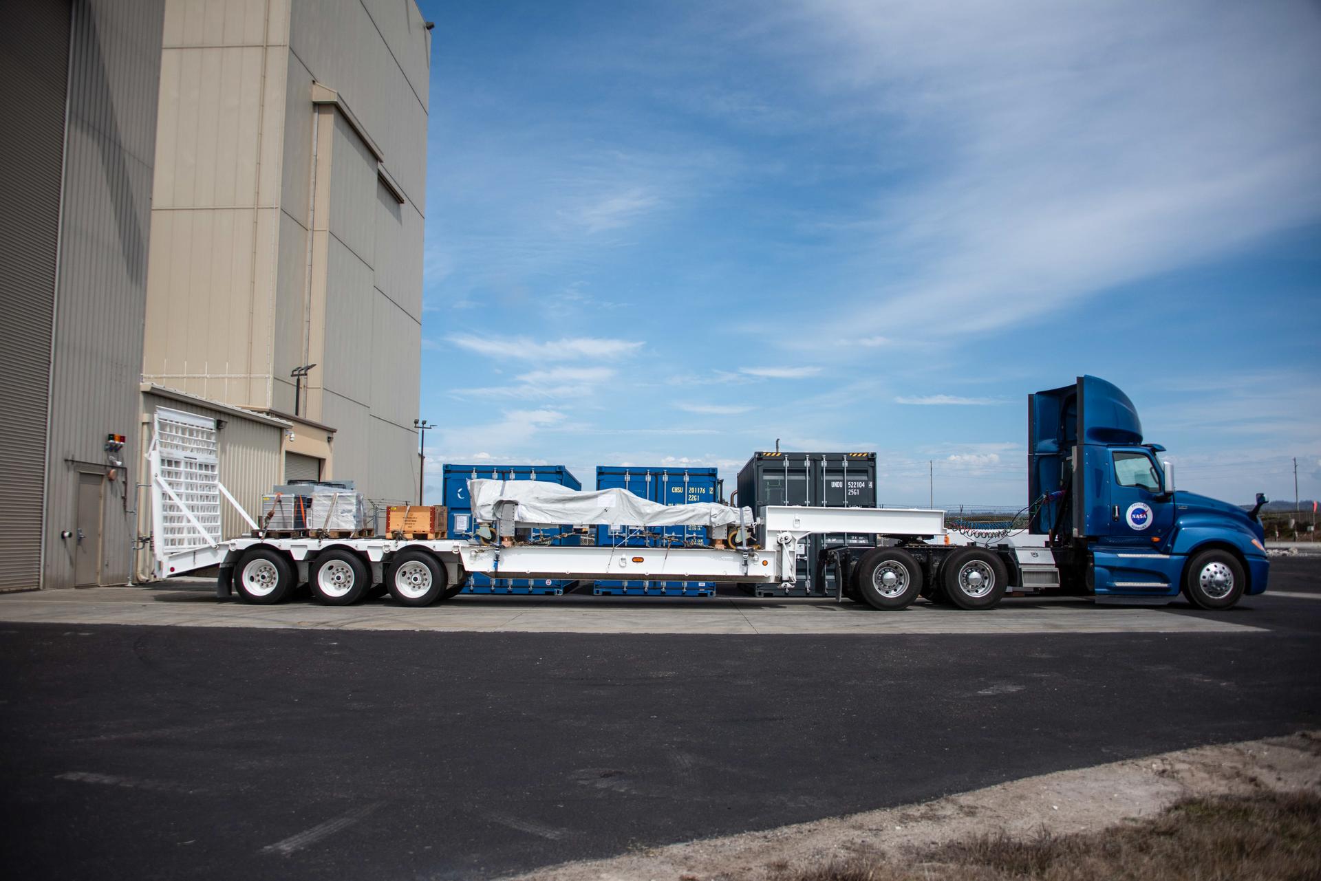 Packed in its shipping container, the Sentinel-6B spacecraft, a collaboration between NASA, ESA (European Space Agency), EUMETSAT (European Organisation for the Exploitation of Meteorological Satellites), and the National Oceanic and Atmospheric Administration (NOAA), arrives by truck to the Astrotech Space Operations payload processing facility at Vandenberg Space Force Base in California on Wednesday, Sept. 17, 2025. The second of two spacecraft that constitutes the Sentinel-6/Jason-CS (Continuity of Service) mission, Sentinel-6B will measure sea surface height and provide crucial information to help improve coastal planning, enabling local and state governments to make informed decisions about protecting coastal infrastructure, real estate, and energy sites. Launch is targeted for no earlier than November on a SpaceX Falcon 9 from Vandenberg.