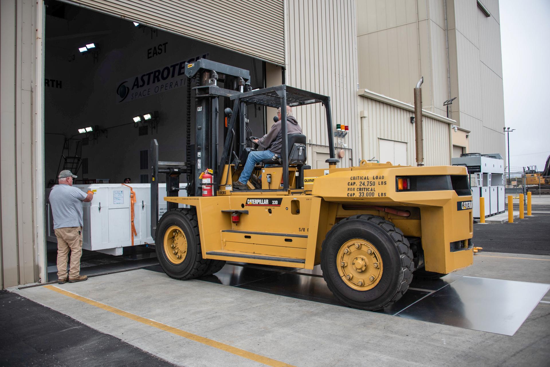 Packed in its shipping container, the Sentinel-6B spacecraft, a collaboration between NASA, ESA (European Space Agency), EUMETSAT (European Organisation for the Exploitation of Meteorological Satellites), and the National Oceanic and Atmospheric Administration (NOAA), arrives by truck to the Astrotech Space Operations payload processing facility at Vandenberg Space Force Base in California on Wednesday, Sept. 17, 2025. The second of two spacecraft that constitutes the Sentinel-6/Jason-CS (Continuity of Service) mission, Sentinel-6B will measure sea surface height and provide crucial information to help improve coastal planning, enabling local and state governments to make informed decisions about protecting coastal infrastructure, real estate, and energy sites. Launch is targeted for no earlier than November on a SpaceX Falcon 9 from Vandenberg.