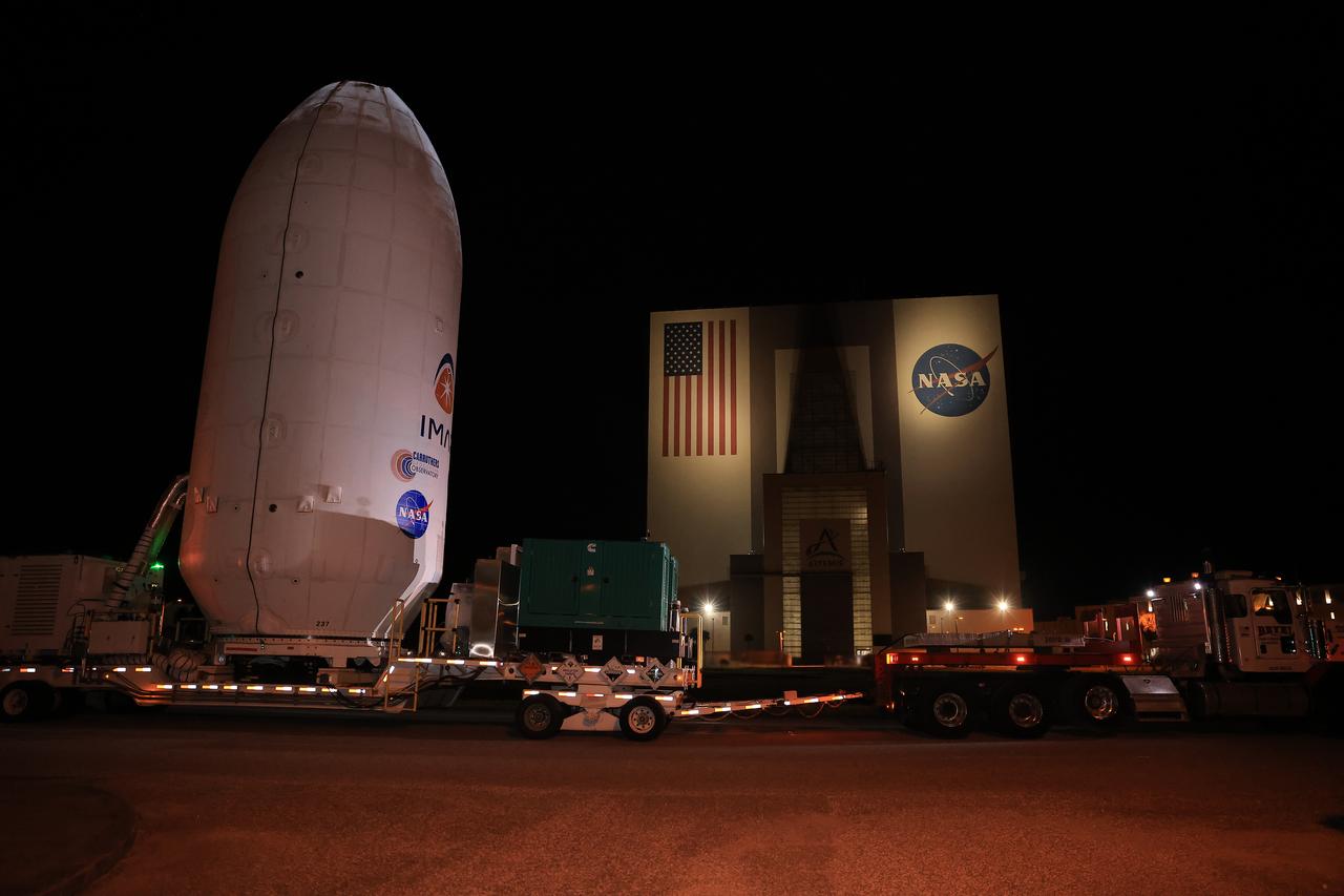 Workers transport NASA’s IMAP (Interstellar Mapping and Acceleration Probe) spacecraft along with the agency’s Carruthers Geocorona Observatory and National Oceanic and Atmospheric Administration’s (NOAA) Space Weather Follow On–Lagrange 1 (SWFO-L1) satellite late on Wednesday, Sept. 17, 2025, through early Thursday, Sept. 18, 2025, from the Astrotech Space Operations Facility in Titusville Florida, to the SpaceX hangar at Launch Complex 39A at the agency’s Kennedy Space Center in Florida. Technicians will soon mate the three spacecraft to a SpaceX Falcon 9 rocket in preparation for launch. Liftoff is targeted for 7:32 a.m. EDT, Tuesday, Sept. 23, from Launch Complex 39A at NASA Kennedy.