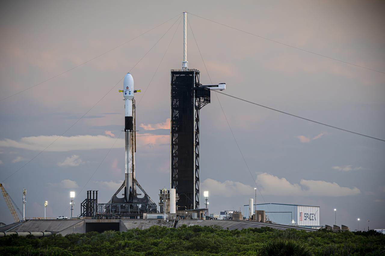 A SpaceX Falcon 9 rocket with NASA’s IMAP (Interstellar Mapping and Acceleration Probe), the agency’s Carruthers Geocorona Observatory, and National Oceanic and Atmospheric Administration’s (NOAA) Space Weather Follow On–Lagrange 1 (SWFO-L1) spacecraft atop stands vertical at Launch Complex 39A as the sun sets on Monday, Sept. 22, 2025, at the agency’s Kennedy Space Center in Florida. The missions will each focus on different effects of the solar wind — the continuous stream of particles emitted by the Sun — and space weather — the changing conditions in space driven by the Sun — from their origins at the Sun to their farthest reaches billions of miles away at the edge of our solar system.