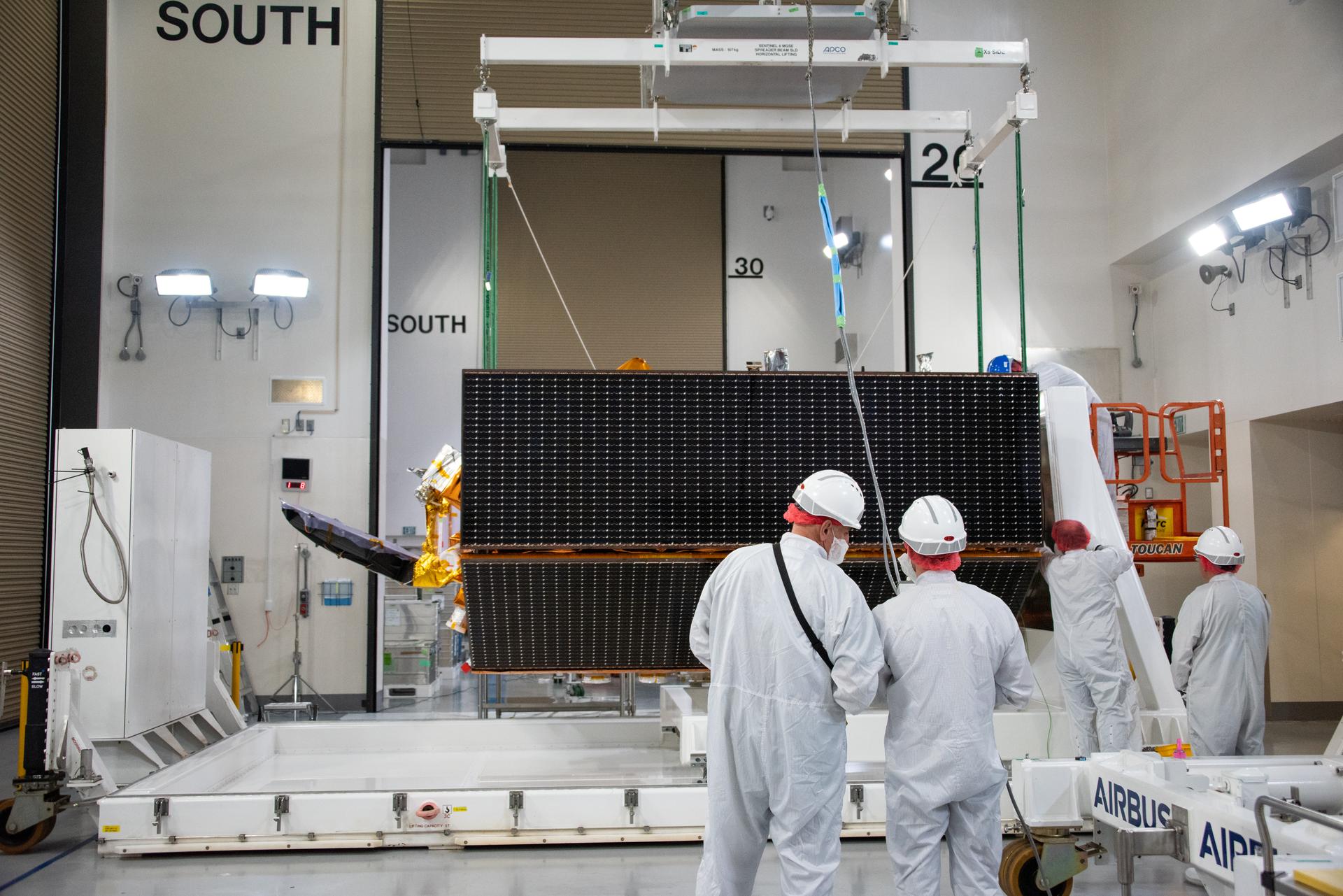 Technicians use a crane to place the Sentinel-6B spacecraft onto a work stand ahead of prelaunch operations at the Astrotech Space Operations payload processing facility at Vandenberg Space Force Base in California on Thursday, Sept. 25, 2025. Sentinel-6B will undergo detailed inspections, tests, and fueling in a cleanroom as it prepares for a November launch on a SpaceX Falcon 9 rocket. A collaboration between NASA, ESA (European Space Agency), EUMETSAT (European Organisation for the Exploitation of Meteorological Satellites), and the National Oceanic and Atmospheric Administration (NOAA), Sentinel-6B is designed to measure sea levels down to roughly an inch for about 90% of the world’s oceans and will extend out to a decade the record of atmospheric temperatures begun by Sentinel-6 Michael Freilich.