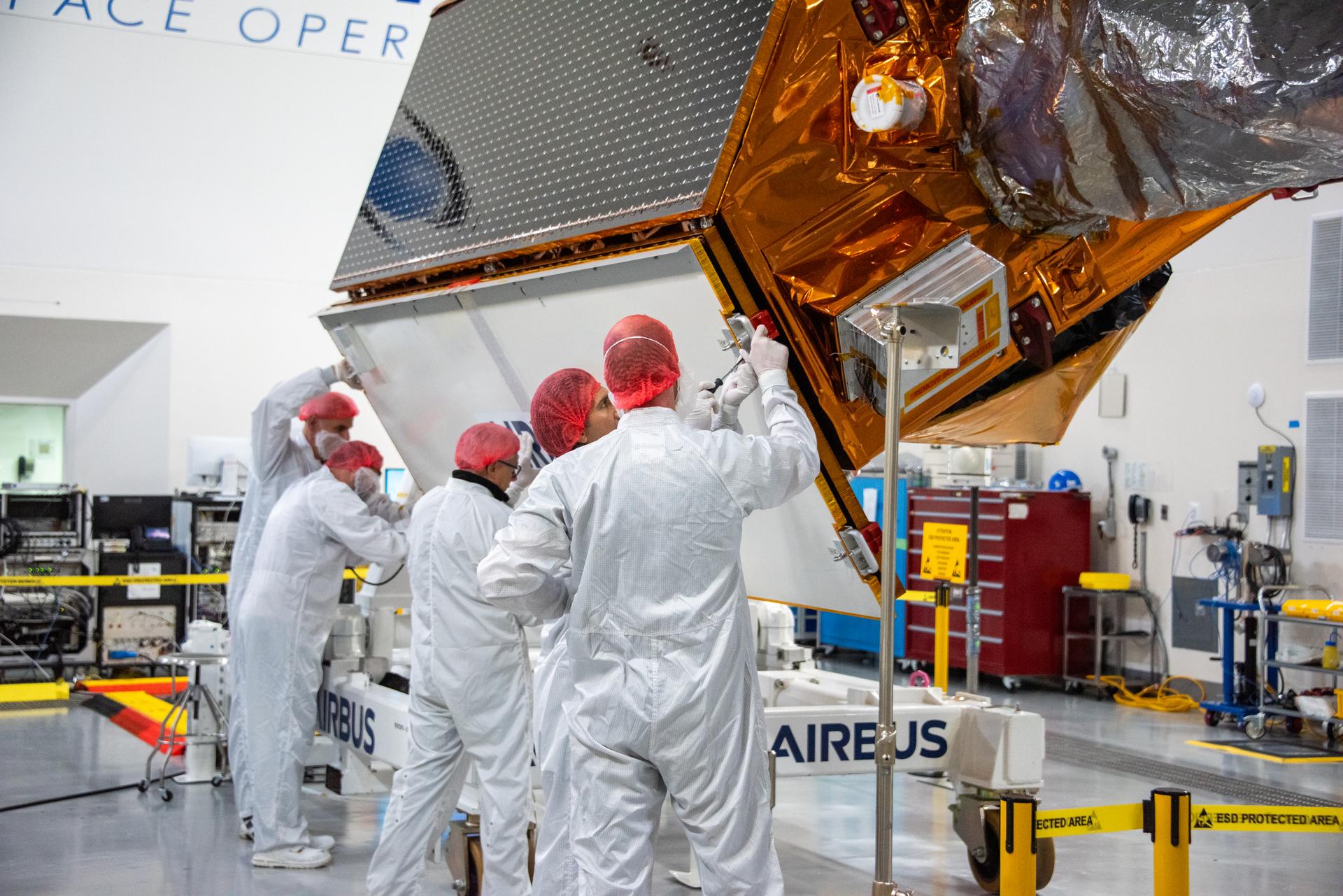 Technicians install protective solar array covers for the Sentinel-6B spacecraft inside the Astrotech Space Operations payload processing facility at Vandenberg Space Force Base in California on Friday, Sept. 26, 2025. Sentinel-6B will undergo detailed inspections, tests, and fueling in a cleanroom as it prepares for a November launch on a SpaceX Falcon 9 rocket. A collaboration between NASA, ESA (European Space Agency), EUMETSAT (European Organisation for the Exploitation of Meteorological Satellites), and the National Oceanic and Atmospheric Administration (NOAA), Sentinel-6B is designed to measure sea levels down to roughly an inch for about 90% of the world’s oceans and will extend out to a decade the record of atmospheric temperatures begun by Sentinel-6 Michael Freilich.