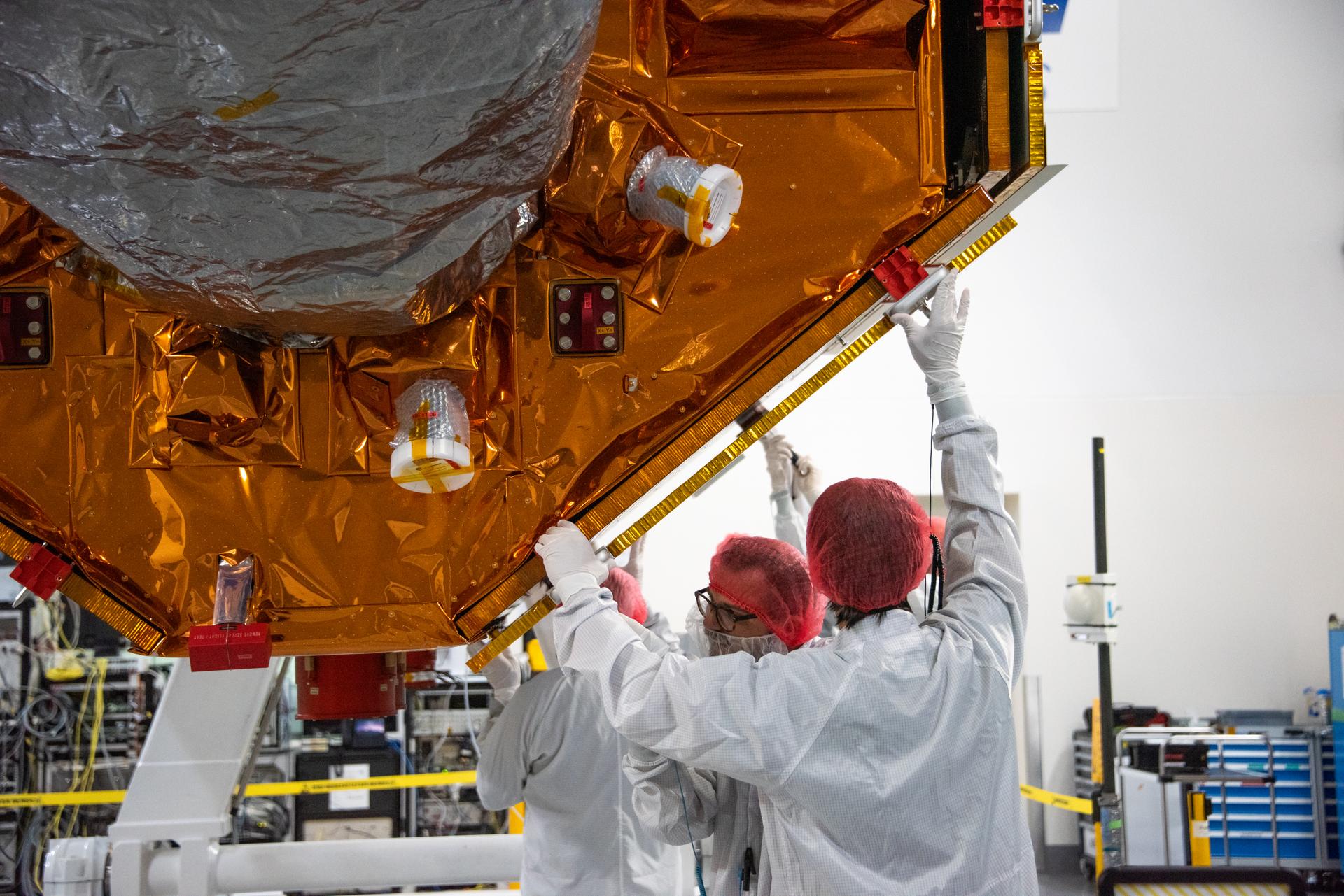 Technicians install protective solar array covers for the Sentinel-6B spacecraft inside the Astrotech Space Operations payload processing facility at Vandenberg Space Force Base in California on Friday, Sept. 26, 2025. Sentinel-6B will undergo detailed inspections, tests, and fueling in a cleanroom as it prepares for a November launch on a SpaceX Falcon 9 rocket. A collaboration between NASA, ESA (European Space Agency), EUMETSAT (European Organisation for the Exploitation of Meteorological Satellites), and the National Oceanic and Atmospheric Administration (NOAA), Sentinel-6B is designed to measure sea levels down to roughly an inch for about 90% of the world’s oceans and will extend out to a decade the record of atmospheric temperatures begun by Sentinel-6 Michael Freilich.