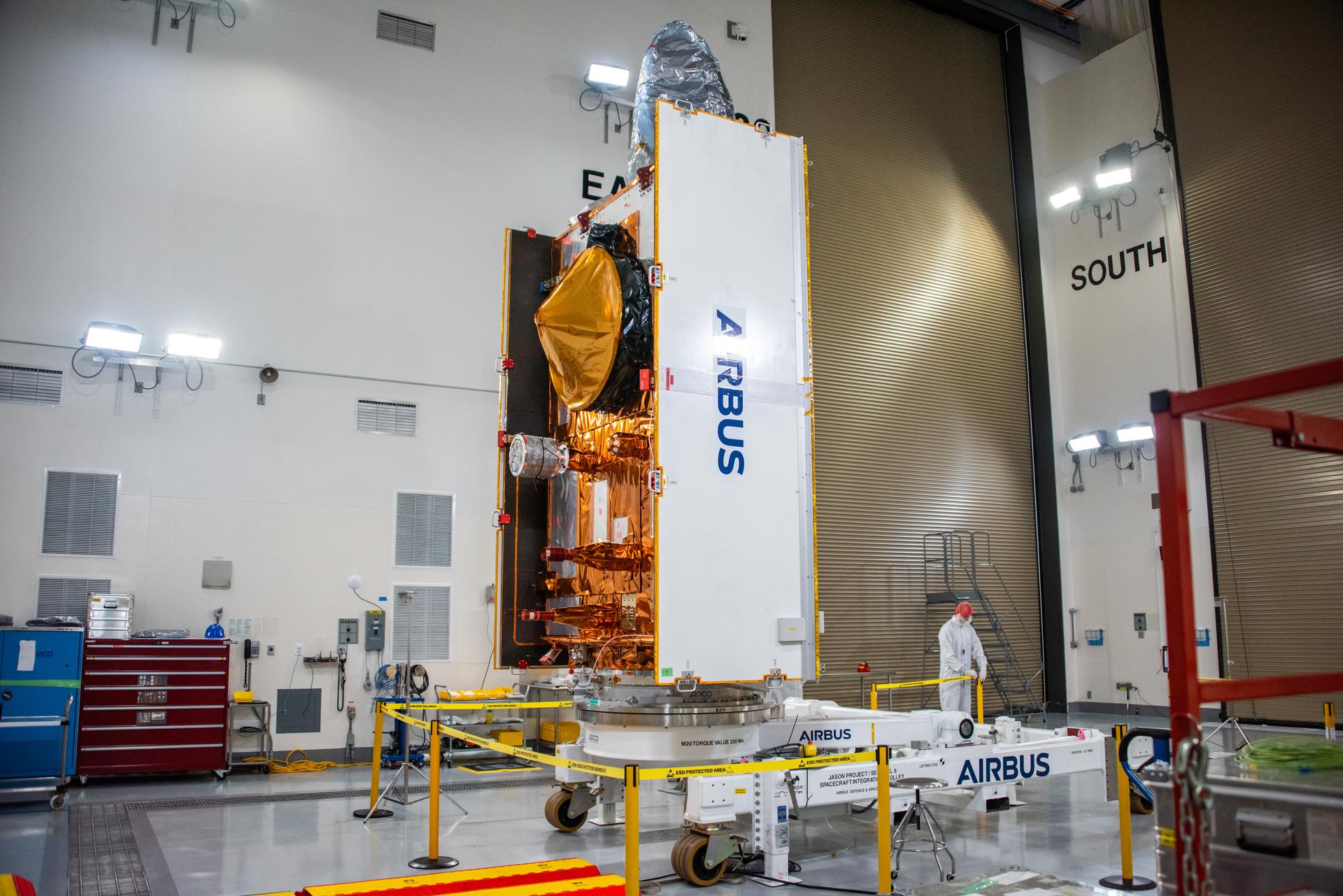 Technicians install protective solar array covers for the Sentinel-6B spacecraft inside the Astrotech Space Operations payload processing facility at Vandenberg Space Force Base in California on Friday, Sept. 26, 2025. Sentinel-6B will undergo detailed inspections, tests, and fueling in a cleanroom as it prepares for a November launch on a SpaceX Falcon 9 rocket. A collaboration between NASA, ESA (European Space Agency), EUMETSAT (European Organisation for the Exploitation of Meteorological Satellites), and the National Oceanic and Atmospheric Administration (NOAA), Sentinel-6B is designed to measure sea levels down to roughly an inch for about 90% of the world’s oceans and will extend out to a decade the record of atmospheric temperatures begun by Sentinel-6 Michael Freilich.