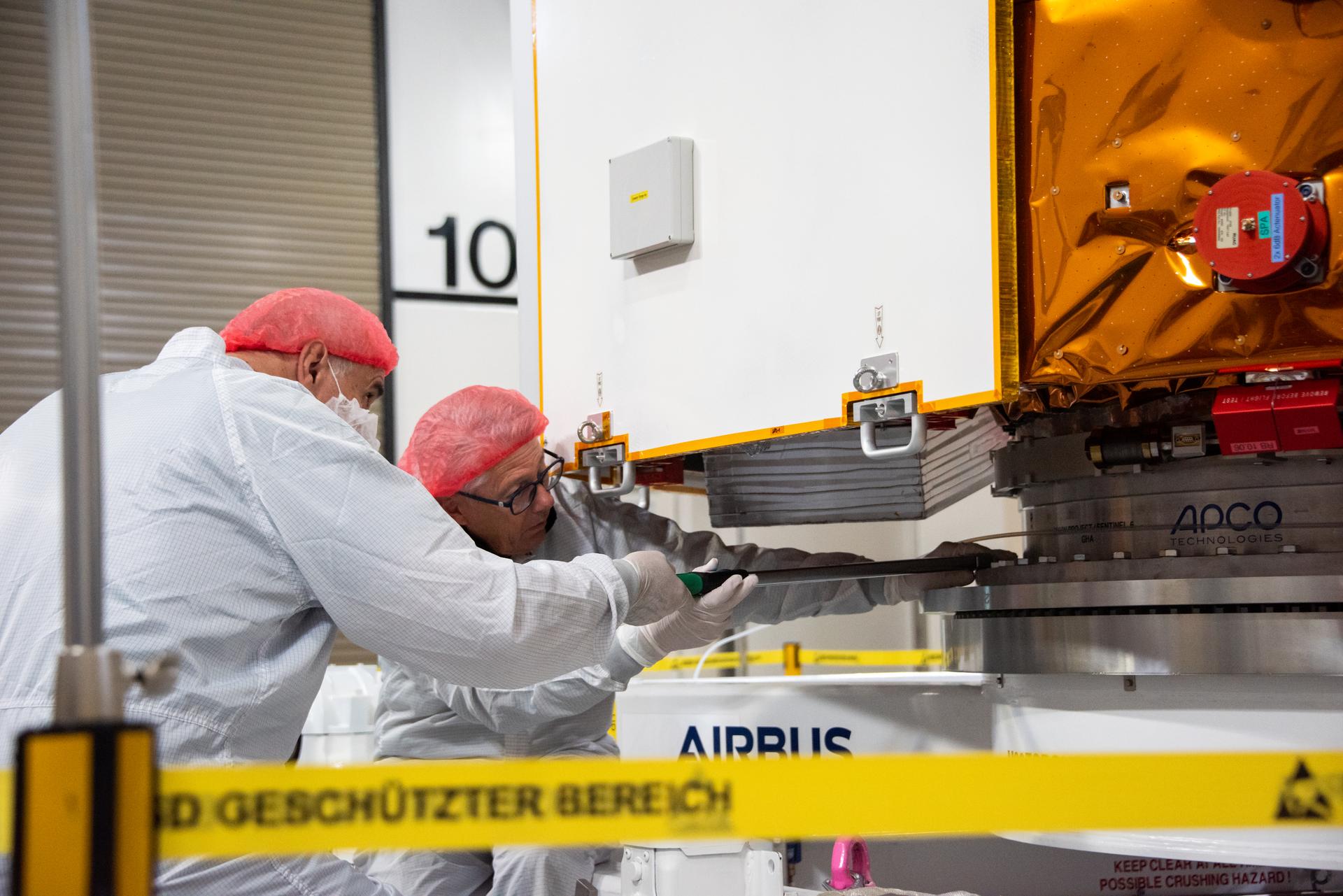 Technicians install protective solar array covers for the Sentinel-6B spacecraft inside the Astrotech Space Operations payload processing facility at Vandenberg Space Force Base in California on Friday, Sept. 26, 2025. Sentinel-6B will undergo detailed inspections, tests, and fueling in a cleanroom as it prepares for a November launch on a SpaceX Falcon 9 rocket. A collaboration between NASA, ESA (European Space Agency), EUMETSAT (European Organisation for the Exploitation of Meteorological Satellites), and the National Oceanic and Atmospheric Administration (NOAA), Sentinel-6B is designed to measure sea levels down to roughly an inch for about 90% of the world’s oceans and will extend out to a decade the record of atmospheric temperatures begun by Sentinel-6 Michael Freilich.