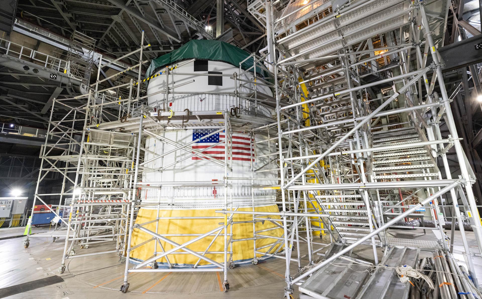 Technicians with NASA’s Exploration Ground Systems Program attach the Orion stage adapter to the interim cryogenic propulsion stage atop the agency’s SLS (Space Launch System) Moon rocket inside Vehicle Assembly Building at NASA’s Kennedy Space Center on Wednesday, Sept. 30, 2025. During the Artemis II test flight, the Orion stage adapter separates from the interim cryogenic propulsion stage, deploying four science payloads into high-Earth orbit. Up next, the Orion spacecraft and its launch abort system will stack atop the Orion stage adapter to complete integration and prepare for the launch of four astronauts around the Moon and back in early 2026.