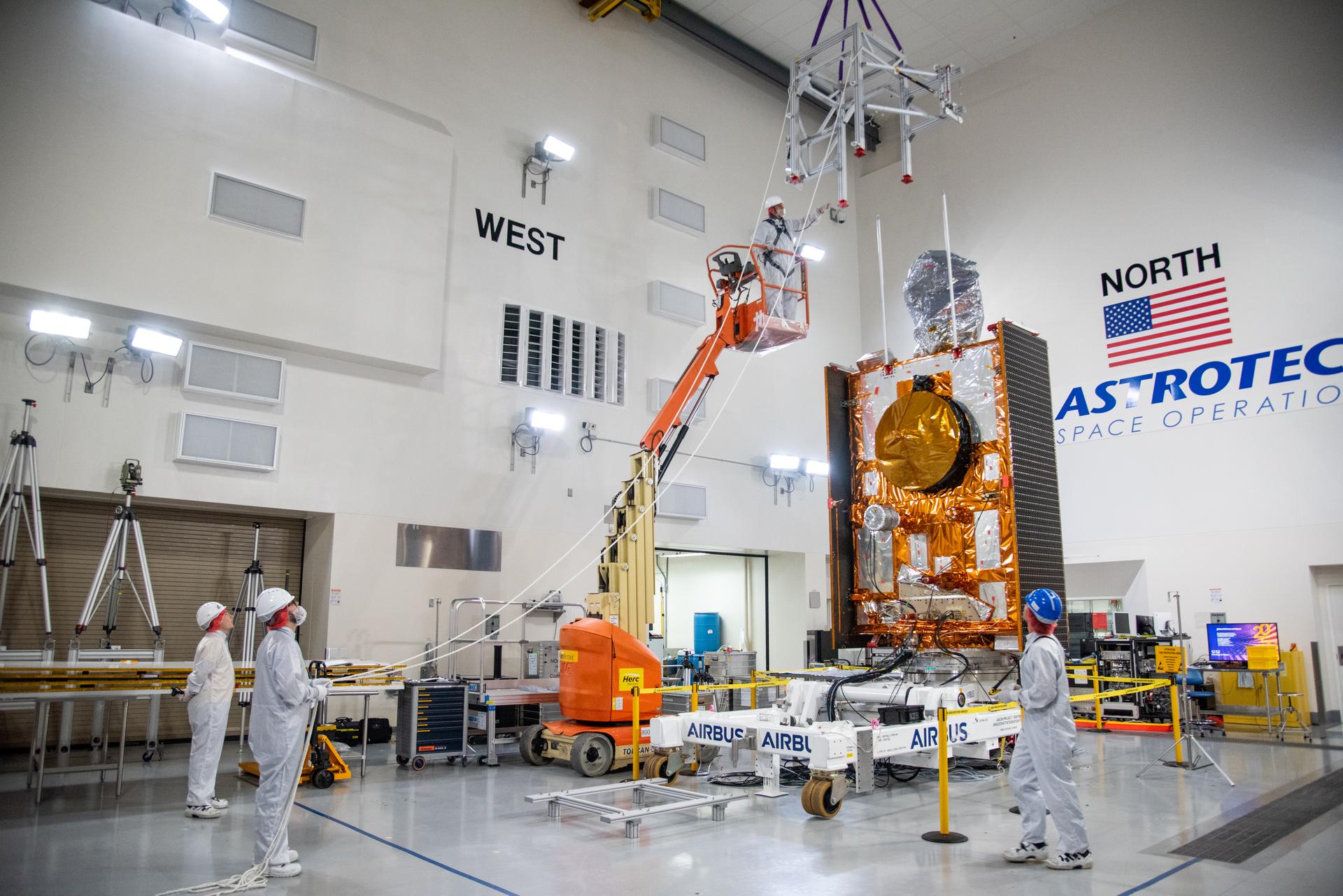 Technicians use a crane during processing of the Sentinel-6B spacecraft on its work stand during prelaunch operations at the Astrotech Space Operations payload processing facility at Vandenberg Space Force Base in California on Thursday, Oct. 16, 2025. Sentinel-6B will undergo detailed inspections, tests, and fueling in a cleanroom as it prepares for a November launch on a SpaceX Falcon 9 rocket. A collaboration between NASA, ESA (European Space Agency), EUMETSAT (European Organisation for the Exploitation of Meteorological Satellites), and the National Oceanic and Atmospheric Administration (NOAA), Sentinel-6B is designed to measure sea levels down to roughly an inch for about 90% of the world’s oceans.