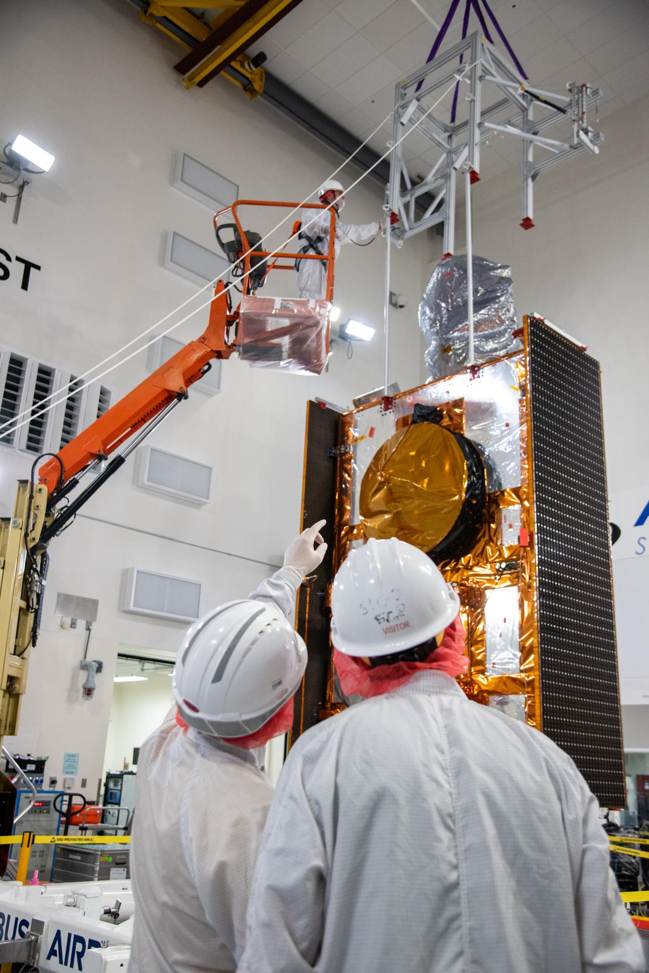 Technicians use a crane during processing of the Sentinel-6B spacecraft on its work stand during prelaunch operations at the Astrotech Space Operations payload processing facility at Vandenberg Space Force Base in California on Thursday, Oct. 16, 2025. Sentinel-6B will undergo detailed inspections, tests, and fueling in a cleanroom as it prepares for a November launch on a SpaceX Falcon 9 rocket. A collaboration between NASA, ESA (European Space Agency), EUMETSAT (European Organisation for the Exploitation of Meteorological Satellites), and the National Oceanic and Atmospheric Administration (NOAA), Sentinel-6B is designed to measure sea levels down to roughly an inch for about 90% of the world’s oceans.