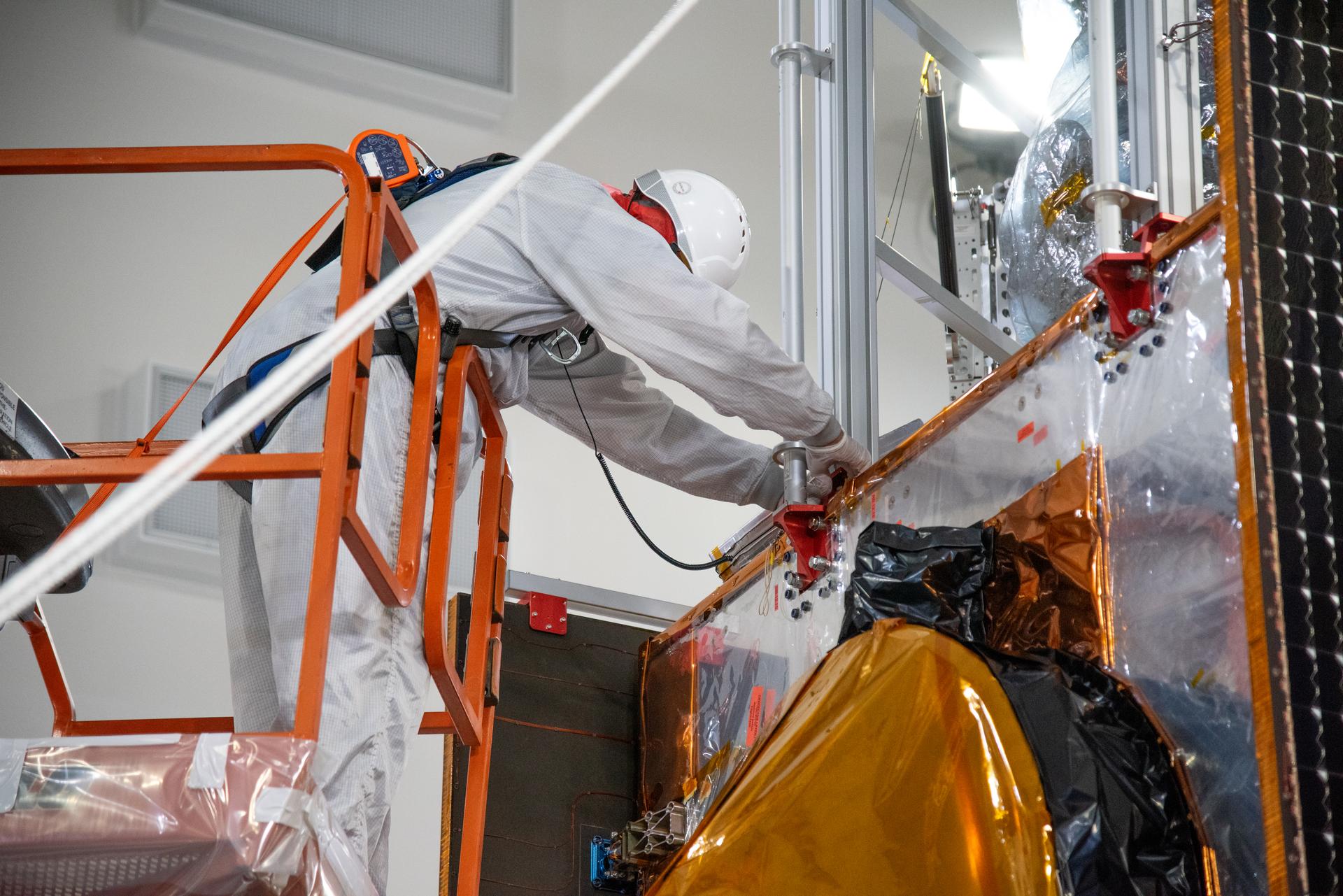 Technicians use a crane during processing of the Sentinel-6B spacecraft on its work stand during prelaunch operations at the Astrotech Space Operations payload processing facility at Vandenberg Space Force Base in California on Thursday, Oct. 16, 2025. Sentinel-6B will undergo detailed inspections, tests, and fueling in a cleanroom as it prepares for a November launch on a SpaceX Falcon 9 rocket. A collaboration between NASA, ESA (European Space Agency), EUMETSAT (European Organisation for the Exploitation of Meteorological Satellites), and the National Oceanic and Atmospheric Administration (NOAA), Sentinel-6B is designed to measure sea levels down to roughly an inch for about 90% of the world’s oceans.