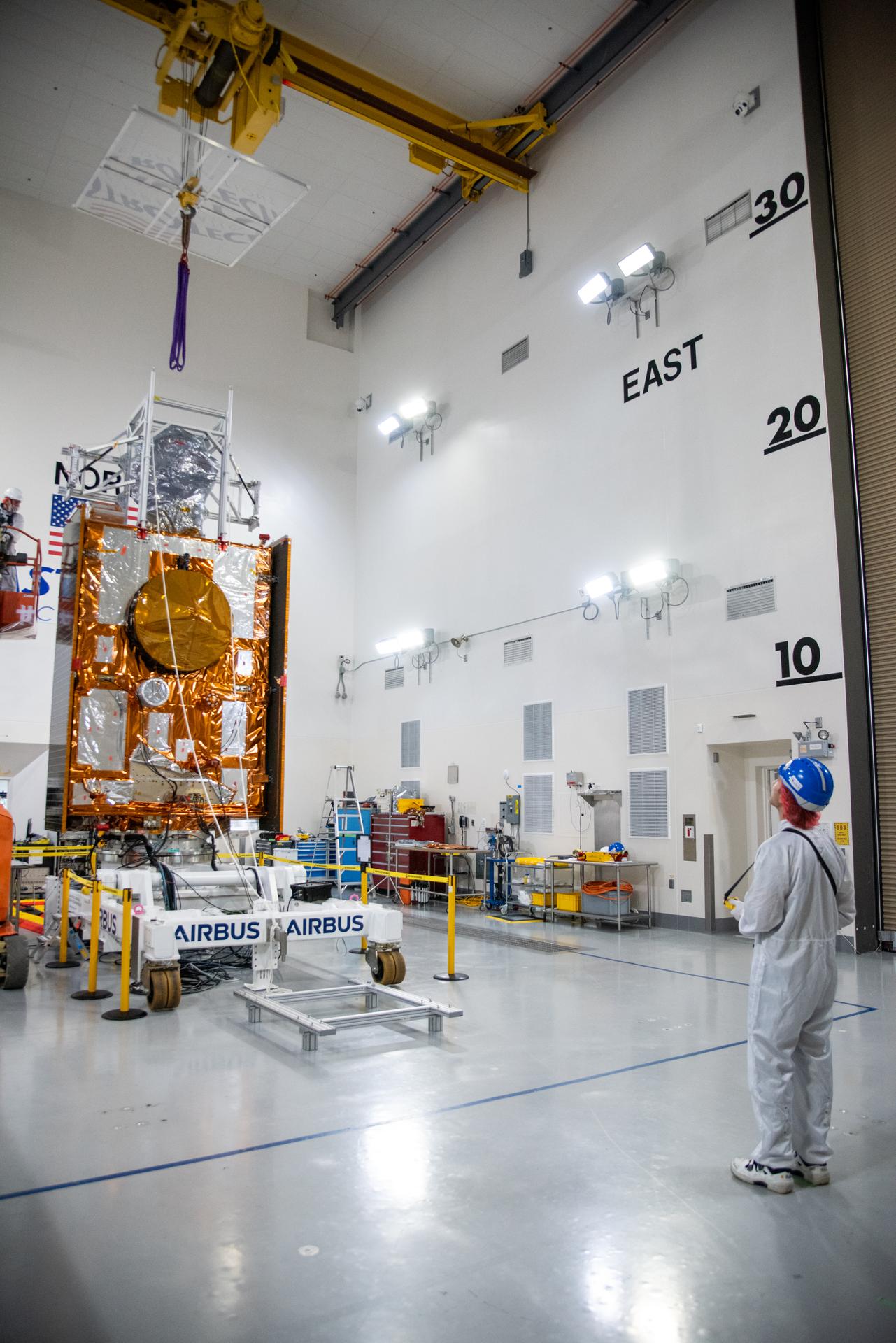 Technicians use a crane during processing of the Sentinel-6B spacecraft on its work stand during prelaunch operations at the Astrotech Space Operations payload processing facility at Vandenberg Space Force Base in California on Thursday, Oct. 16, 2025. Sentinel-6B will undergo detailed inspections, tests, and fueling in a cleanroom as it prepares for a November launch on a SpaceX Falcon 9 rocket. A collaboration between NASA, ESA (European Space Agency), EUMETSAT (European Organisation for the Exploitation of Meteorological Satellites), and the National Oceanic and Atmospheric Administration (NOAA), Sentinel-6B is designed to measure sea levels down to roughly an inch for about 90% of the world’s oceans.