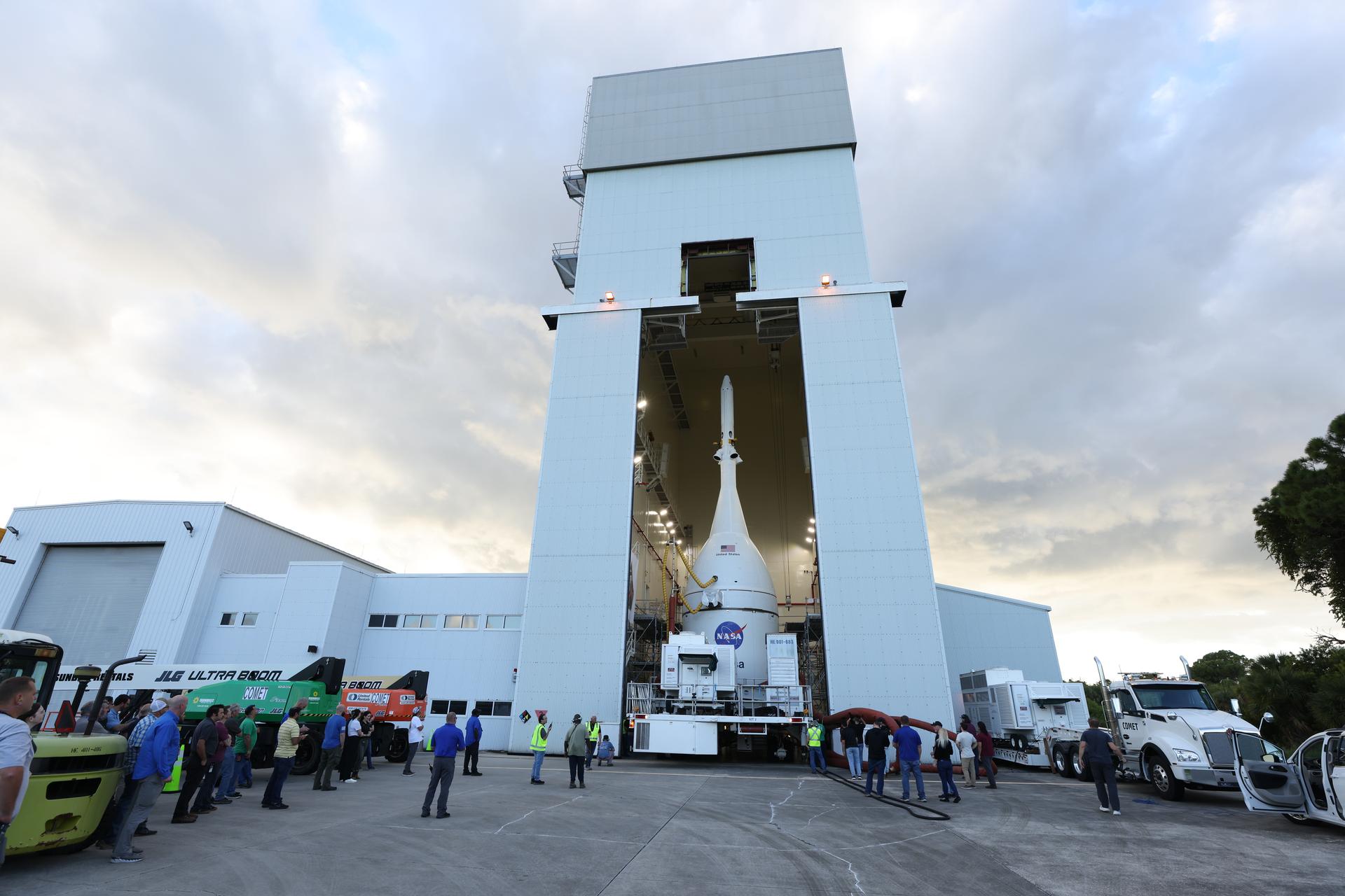 Technicians with NASA’s Exploration Ground Systems team transport NASA’s Orion spacecraft fully assembled with its launch abort system out of the Launch Abort System Facility to the Vehicle Assembly Building at NASA’s Kennedy Space Center in Florida on Thursday, Oct. 16, 2025. Once at the Vehicle Assembly Building, Orion will be stacked atop the SLS (Space Launch System) rocket in High Bay 3 to prepare for the Artemis II mission set to carry NASA astronauts Reid Wiseman, Victor Glover, Christina Koch, and CSA (Canadian Space Agency) astronaut Jeremy Hansen on a 10-day mission around the Moon and back in early 2026.