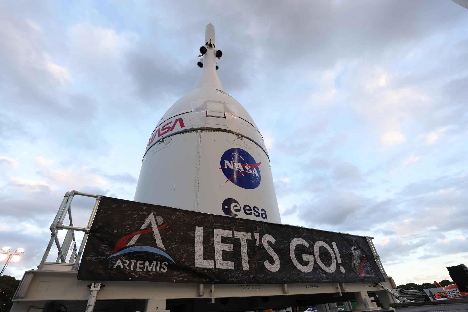 Technicians with NASA’s Exploration Ground Systems team transport NASA’s Orion spacecraft fully assembled with its launch abort system out of the Launch Abort System Facility to the Vehicle Assembly Building at NASA’s Kennedy Space Center in Florida on Thursday, Oct. 16, 2025. Once at the Vehicle Assembly Building, Orion will be stacked atop the SLS (Space Launch System) rocket in High Bay 3 to prepare for the Artemis II mission set to carry NASA astronauts Reid Wiseman, Victor Glover, Christina Koch, and CSA (Canadian Space Agency) astronaut Jeremy Hansen on a 10-day mission around the Moon and back in early 2026.