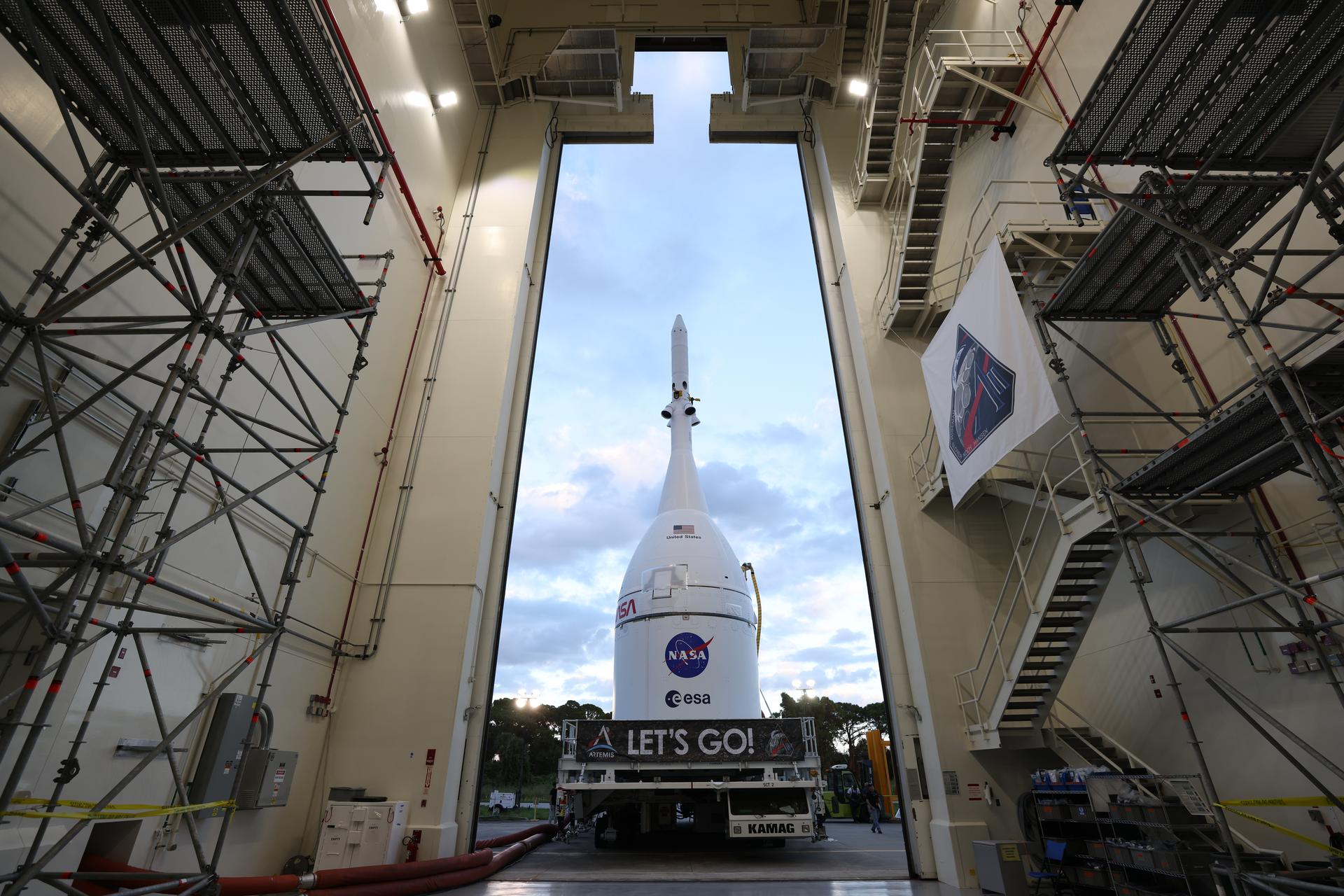 Technicians with NASA’s Exploration Ground Systems team transport NASA’s Orion spacecraft fully assembled with its launch abort system out of the Launch Abort System Facility to the Vehicle Assembly Building at NASA’s Kennedy Space Center in Florida on Thursday, Oct. 16, 2025. Once at the Vehicle Assembly Building, Orion will be stacked atop the SLS (Space Launch System) rocket in High Bay 3 to prepare for the Artemis II mission set to carry NASA astronauts Reid Wiseman, Victor Glover, Christina Koch, and CSA (Canadian Space Agency) astronaut Jeremy Hansen on a 10-day mission around the Moon and back in early 2026.