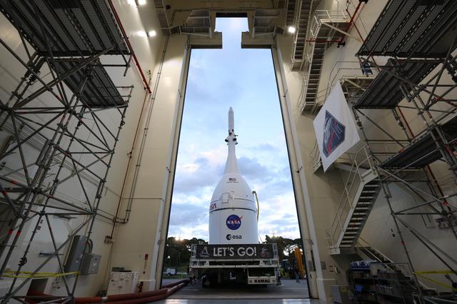 Technicians with NASA’s Exploration Ground Systems team transport NASA’s Orio...
