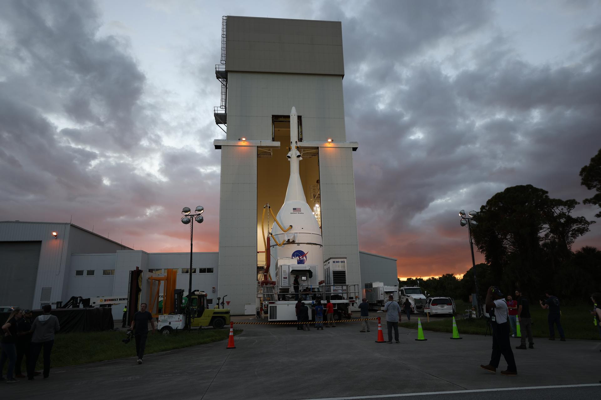 Technicians with NASA’s Exploration Ground Systems team transport NASA’s Orion spacecraft fully assembled with its launch abort system out of the Launch Abort System Facility to the Vehicle Assembly Building at NASA’s Kennedy Space Center in Florida on Thursday, Oct. 16, 2025. Once at the Vehicle Assembly Building, Orion will be stacked atop the SLS (Space Launch System) rocket in High Bay 3 to prepare for the Artemis II mission set to carry NASA astronauts Reid Wiseman, Victor Glover, Christina Koch, and CSA (Canadian Space Agency) astronaut Jeremy Hansen on a 10-day mission around the Moon and back in early 2026.