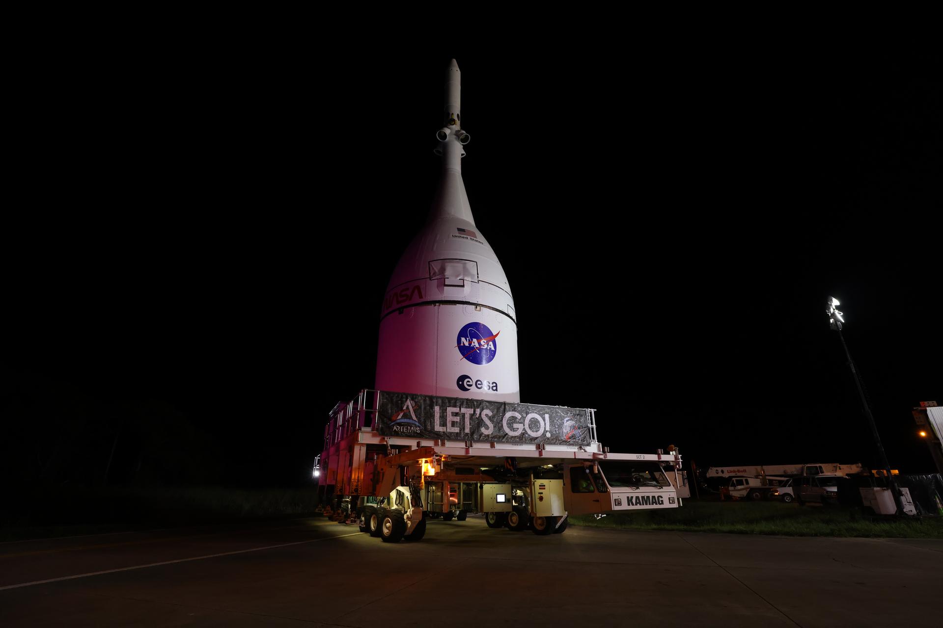 Technicians with NASA’s Exploration Ground Systems team transport NASA’s Orion spacecraft fully assembled with its launch abort system out of the Launch Abort System Facility to the Vehicle Assembly Building at NASA’s Kennedy Space Center in Florida on Thursday, Oct. 16, 2025. Once at the Vehicle Assembly Building, Orion will be stacked atop the SLS (Space Launch System) rocket in High Bay 3 to prepare for the Artemis II mission set to carry NASA astronauts Reid Wiseman, Victor Glover, Christina Koch, and CSA (Canadian Space Agency) astronaut Jeremy Hansen on a 10-day mission around the Moon and back in early 2026.
