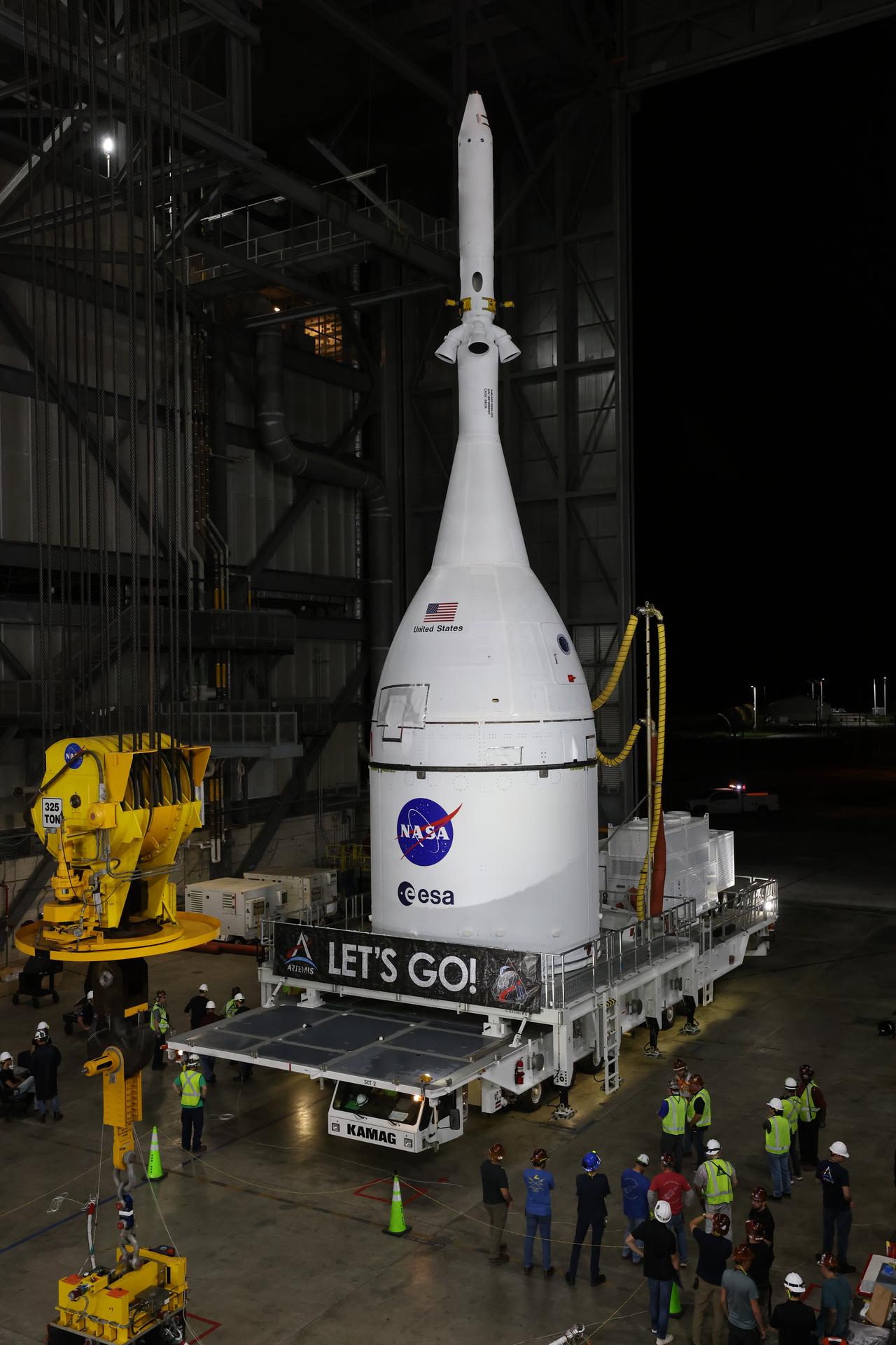 Technicians with NASA’s Exploration Ground Systems team transport NASA’s Orion spacecraft fully assembled with its launch abort system out of the Launch Abort System Facility to the Vehicle Assembly Building at NASA’s Kennedy Space Center in Florida on Thursday, Oct. 16, 2025. Once at the Vehicle Assembly Building, Orion will be stacked atop the SLS (Space Launch System) rocket in High Bay 3 to prepare for the Artemis II mission set to carry NASA astronauts Reid Wiseman, Victor Glover, Christina Koch, and CSA (Canadian Space Agency) astronaut Jeremy Hansen on a 10-day mission around the Moon and back in early 2026.