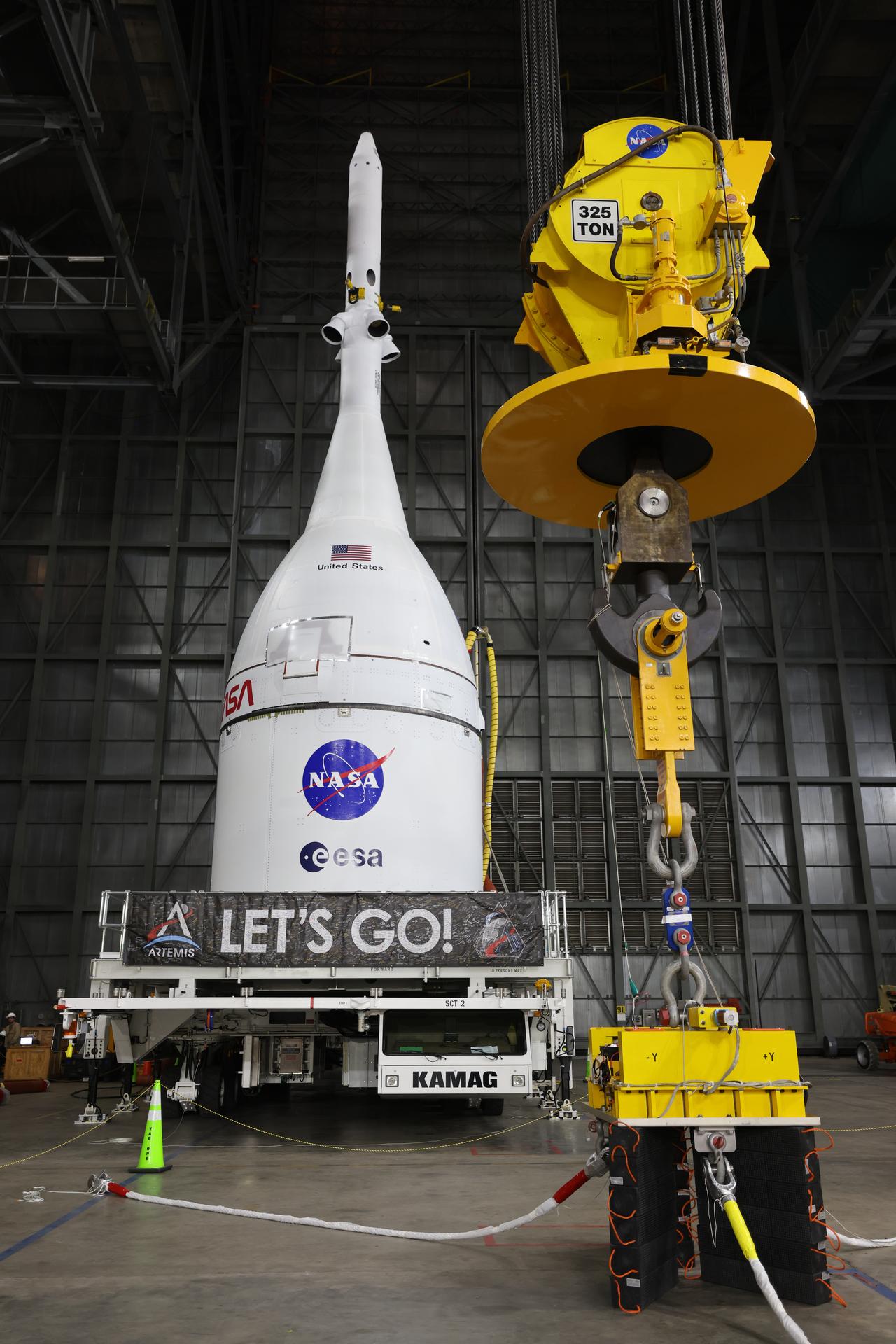 Technicians with NASA’s Exploration Ground Systems team prepare to attach a crane to lift and secure NASA’s Orion spacecraft on top of the SLS (Space Launch System) rocket in High Bay 3 of the Vehicle Assembly Building at NASA’s Kennedy Space Center in Florida on Friday, Oct. 17, 2025, for the agency’s Artemis II mission. Set to launch in 2026, the spacecraft will carry NASA astronauts Reid Wiseman, Victor Glover, Christina Koch, and CSA (Canadian Space Agency) astronaut Jeremy Hansen on a 10-day mission around the Moon and back. Once stacked, teams will begin conducting a series of verification tests ahead of rolling out to Launch Complex 39B for the wet dress rehearsal at NASA Kennedy. 