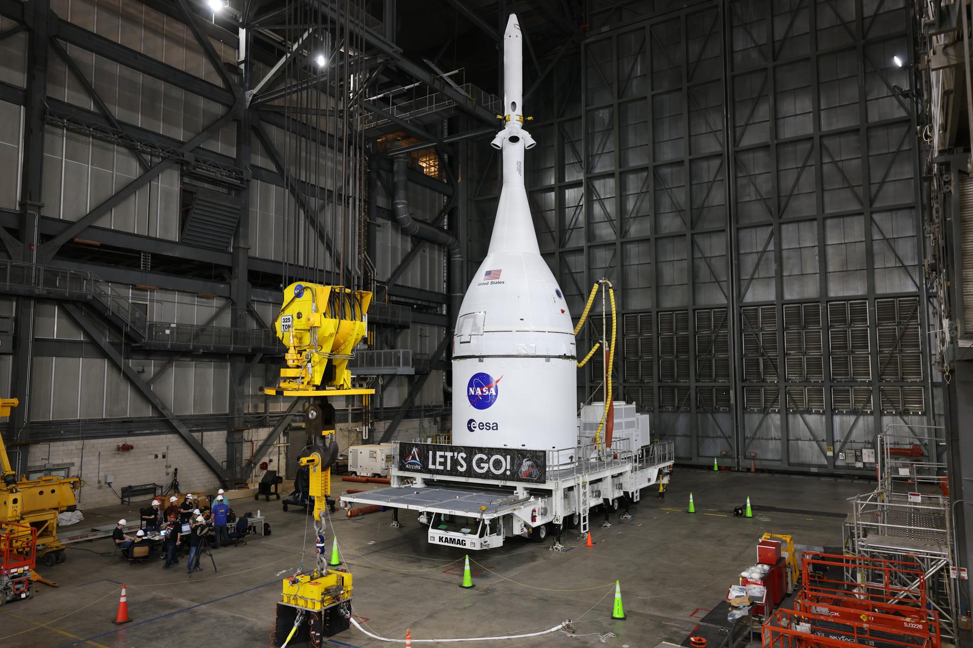 Technicians with NASA’s Exploration Ground Systems team prepare to attach a crane to lift and secure NASA’s Orion spacecraft on top of the SLS (Space Launch System) rocket in High Bay 3 of the Vehicle Assembly Building at NASA’s Kennedy Space Center in Florida on Friday, Oct. 17, 2025, for the agency’s Artemis II mission. Set to launch in 2026, the spacecraft will carry NASA astronauts Reid Wiseman, Victor Glover, Christina Koch, and CSA (Canadian Space Agency) astronaut Jeremy Hansen on a 10-day mission around the Moon and back. Once stacked, teams will begin conducting a series of verification tests ahead of rolling out to Launch Complex 39B for the wet dress rehearsal at NASA Kennedy. 