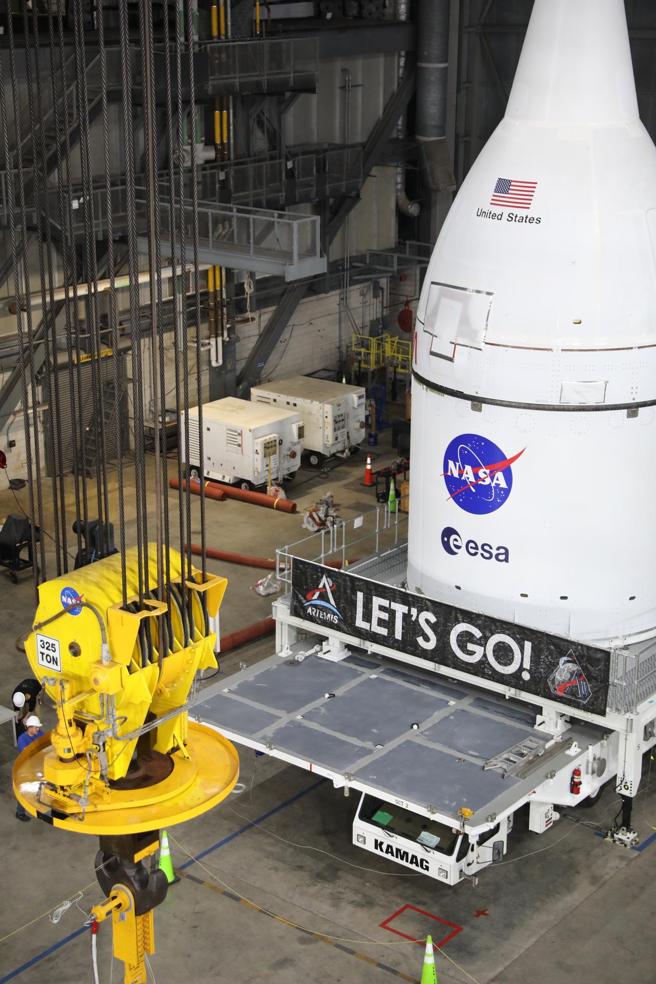 Technicians with NASA’s Exploration Ground Systems team prepare to attach a crane to lift and secure NASA’s Orion spacecraft on top of the SLS (Space Launch System) rocket in High Bay 3 of the Vehicle Assembly Building at NASA’s Kennedy Space Center in Florida on Friday, Oct. 17, 2025, for the agency’s Artemis II mission. Set to launch in 2026, the spacecraft will carry NASA astronauts Reid Wiseman, Victor Glover, Christina Koch, and CSA (Canadian Space Agency) astronaut Jeremy Hansen on a 10-day mission around the Moon and back. Once stacked, teams will begin conducting a series of verification tests ahead of rolling out to Launch Complex 39B for the wet dress rehearsal at NASA Kennedy. 
