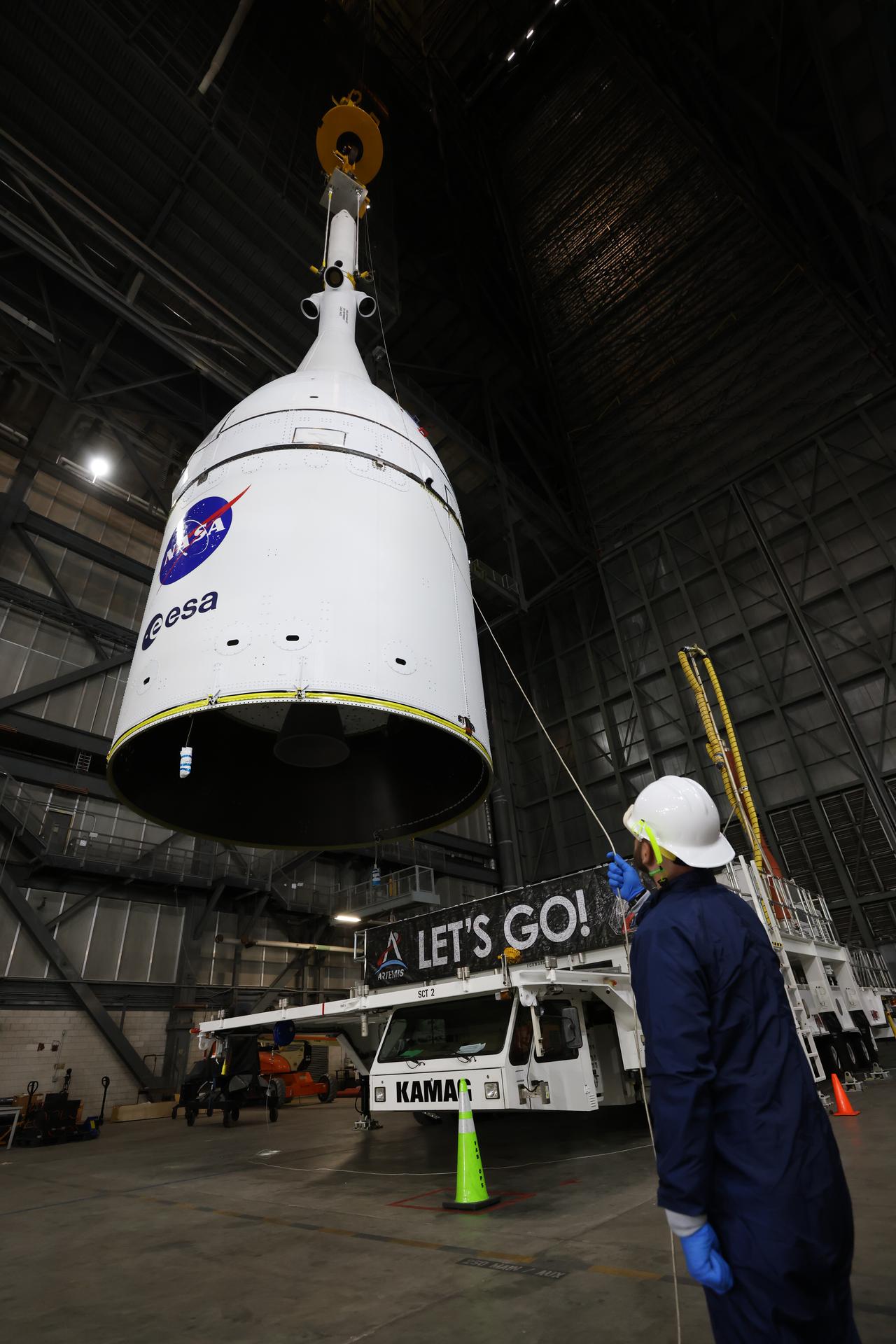 Technicians with NASA’s Exploration Ground Systems team use a crane to lift NASA’s Orion spacecraft off a KAMAG transporter to prepare for integration on top of the SLS (Space Launch System) rocket in High Bay 3 of the Vehicle Assembly Building at NASA’s Kennedy Space Center in Florida on Friday, Oct. 17, 2025, for the agency’s Artemis II mission. Set to launch in 2026, the spacecraft will carry NASA astronauts Reid Wiseman, Victor Glover, Christina Koch, and CSA (Canadian Space Agency) astronaut Jeremy Hansen on a 10-day mission around the Moon and back. Once stacked, teams will begin conducting a series of verification tests ahead of rolling out to Launch Complex 39B for the wet dress rehearsal at NASA Kennedy.