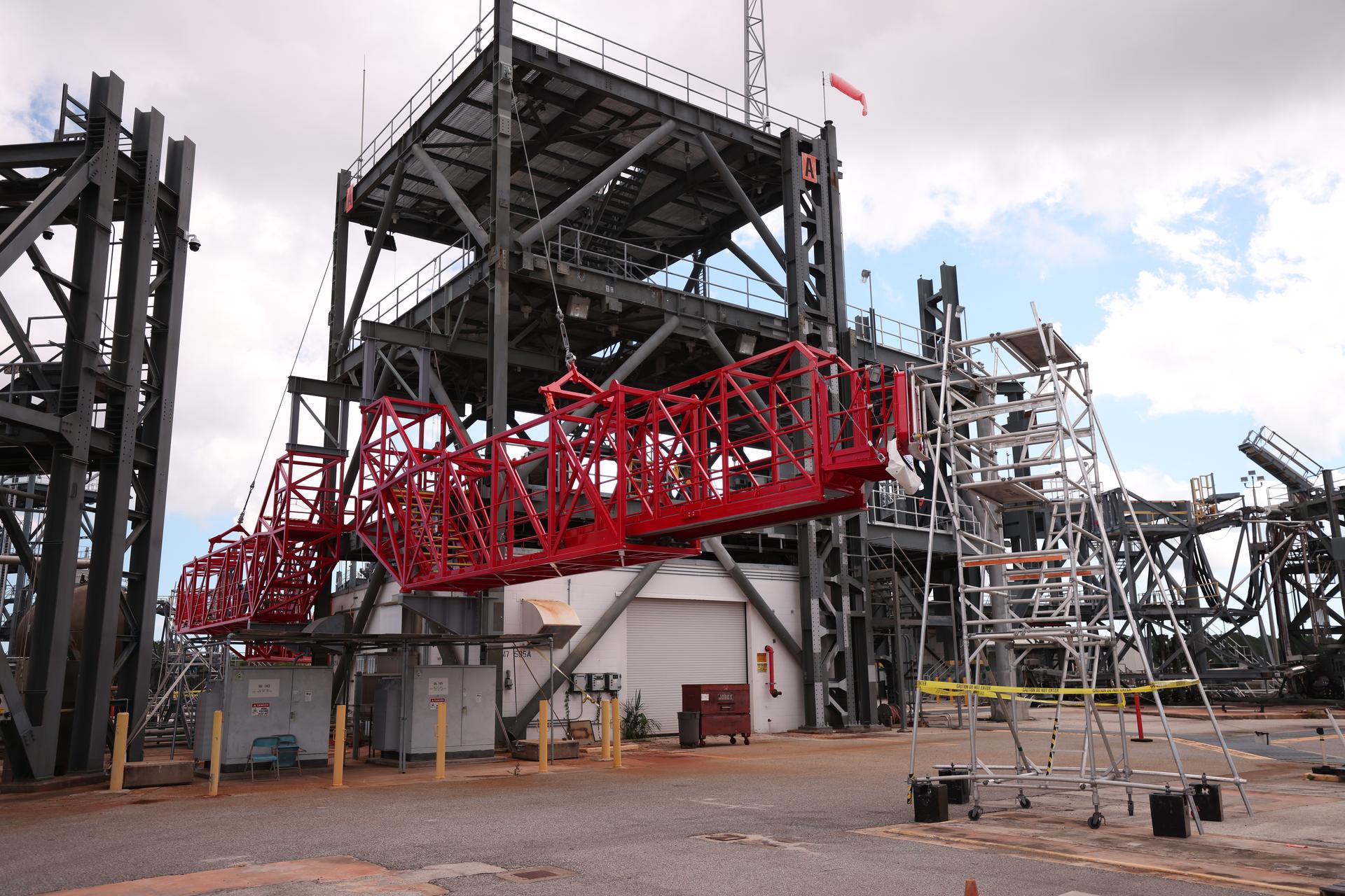 Crews test temporary contingency access platforms on the mobile launcher simulator tower on Wednesday, Oct. 29, 2025, at the Launch Equipment Test Facility at NASA’s Kennedy Space Center in Florida. The platforms will allow engineers to access the vehicle’s flight termination system on the rocket and the mobile launcher while at the pad rather than rolling back to the Vehicle Assembly Building to retest them. For Artemis II, four astronauts will venture around the Moon in early 2026, the first crewed mission on NASA’s path to establishing a long-term presence for science and exploration through Artemis.