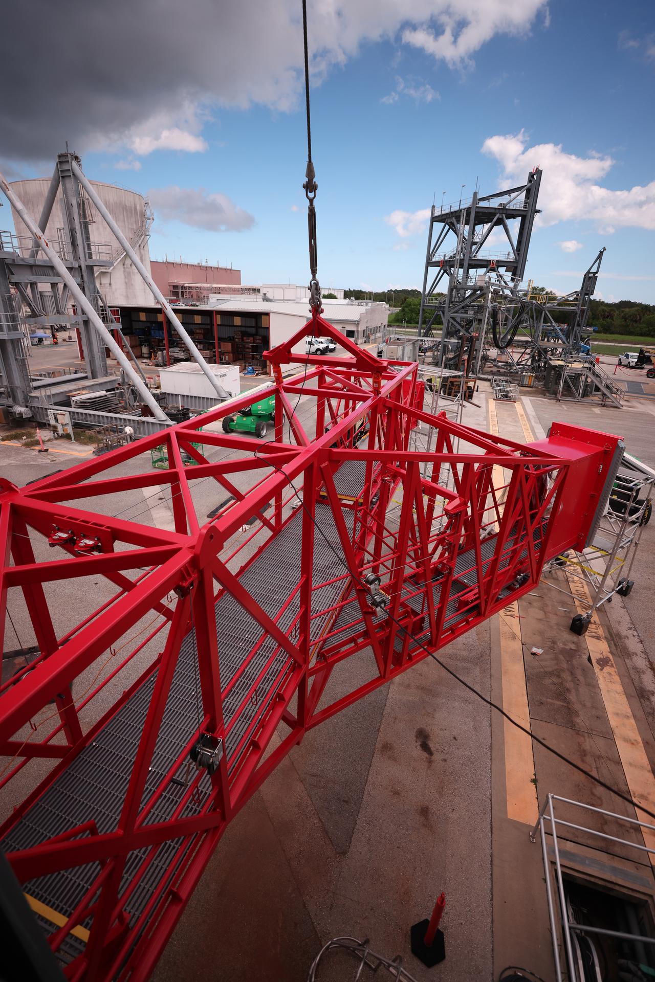 Crews test temporary contingency access platforms on the mobile launcher simulator tower on Wednesday, Oct. 29, 2025, at the Launch Equipment Test Facility at NASA’s Kennedy Space Center in Florida. The platforms will allow engineers to access the vehicle’s flight termination system on the rocket and the mobile launcher while at the pad rather than rolling back to the Vehicle Assembly Building to retest them. For Artemis II, four astronauts will venture around the Moon in early 2026, the first crewed mission on NASA’s path to establishing a long-term presence for science and exploration through Artemis.