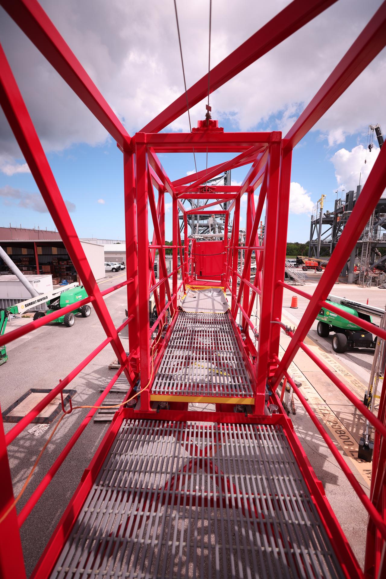 Crews test temporary contingency access platforms on the mobile launcher simulator tower on Wednesday, Oct. 29, 2025, at the Launch Equipment Test Facility at NASA’s Kennedy Space Center in Florida. The platforms will allow engineers to access the vehicle’s flight termination system on the rocket and the mobile launcher while at the pad rather than rolling back to the Vehicle Assembly Building to retest them. For Artemis II, four astronauts will venture around the Moon in early 2026, the first crewed mission on NASA’s path to establishing a long-term presence for science and exploration through Artemis.