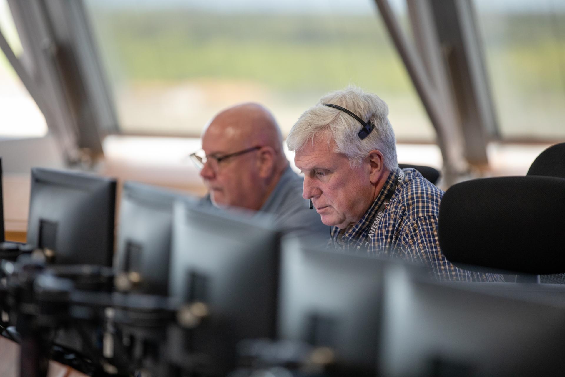 From left, John Honeycutt, Artemis II mission management team chair and Matthew Ramsey, Artemis II mission manager with NASA’s Exploration Systems Development Mission Directorate, participate in an Artemis II launch countdown simulation inside Firing Room 1 in the Launch Control Center at NASA’s Kennedy Space Center in Florida on Wednesday, Nov. 5, 2025. The simulations go through launch day scenarios to help launch team members test software and make adjustments if needed during countdown operations. For Artemis II, four astronauts will venture around the Moon, the first crewed mission on NASA’s path to establishing a long-term presence for science and exploration through Artemis. 
