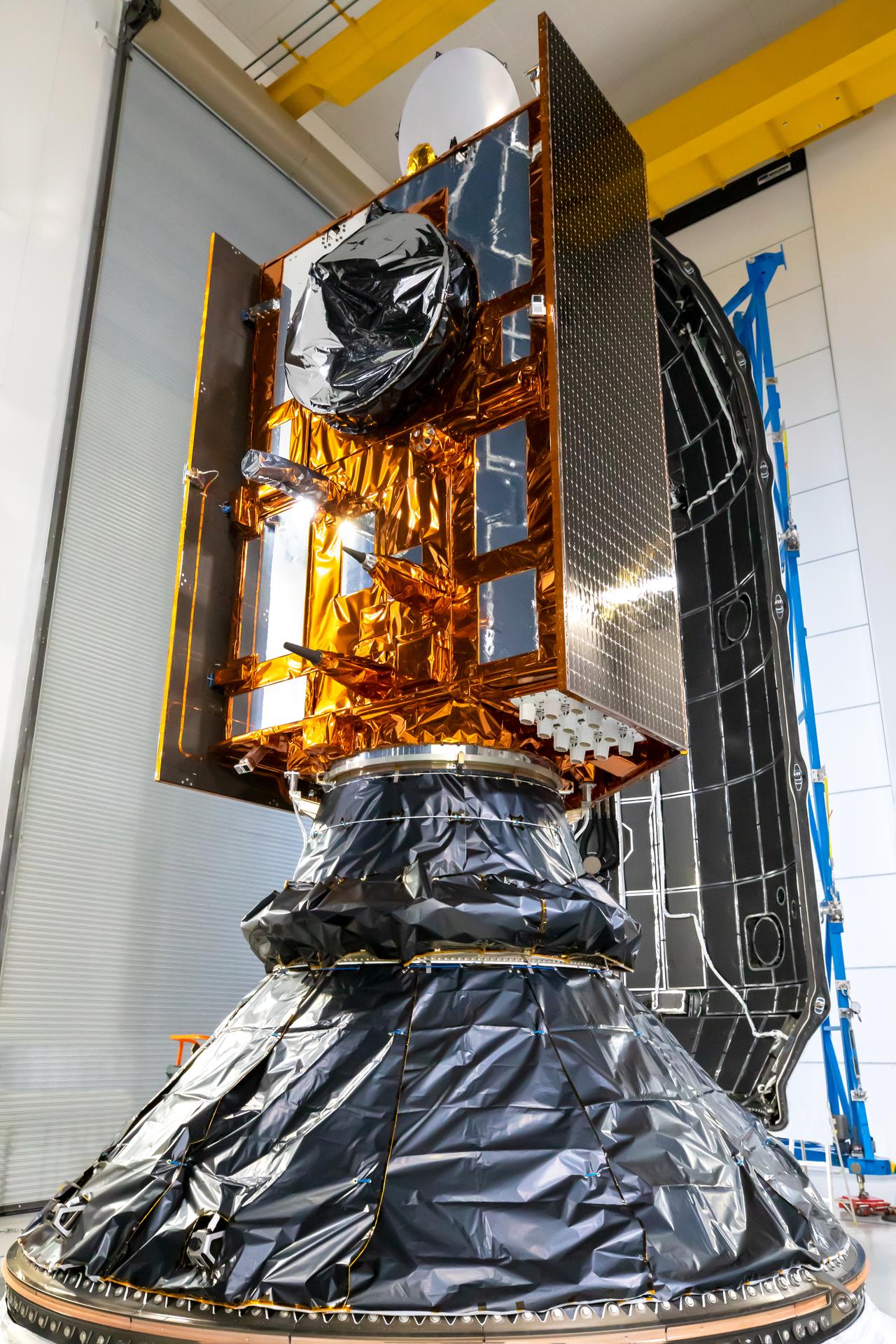 Image shows a spacecraft encapsulated in silver and copper foil