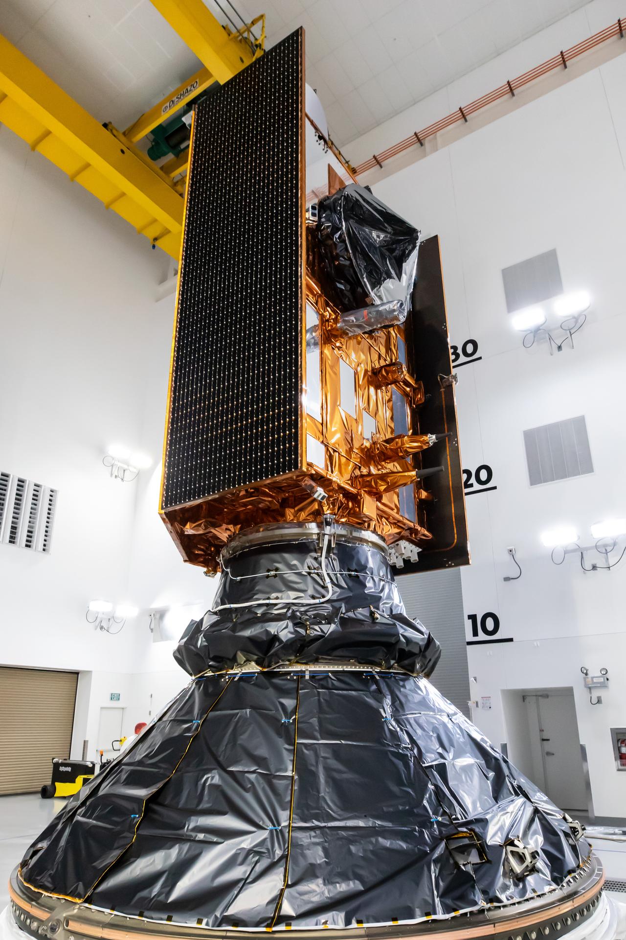 Technicians and engineers encapsulate the Sentinel-6B spacecraft within a protective payload fairing inside the Astrotech Space Operations facility at Vandenberg Space Force Base in California, on Monday, Nov. 10, 2025. A collaboration between NASA, ESA (European Space Agency), EUMETSAT (European Organisation for the Exploitation of Meteorological Satellites), and the National Oceanic and Atmospheric Administration (NOAA), Sentinel-6B is designed to measure sea levels down to roughly an inch for about 90% of the world’s oceans. NASA is targeting launch no earlier than Sunday, Nov. 16, on a SpaceX Falcon 9 rocket from Space Launch Complex 4 East at Vandenberg.