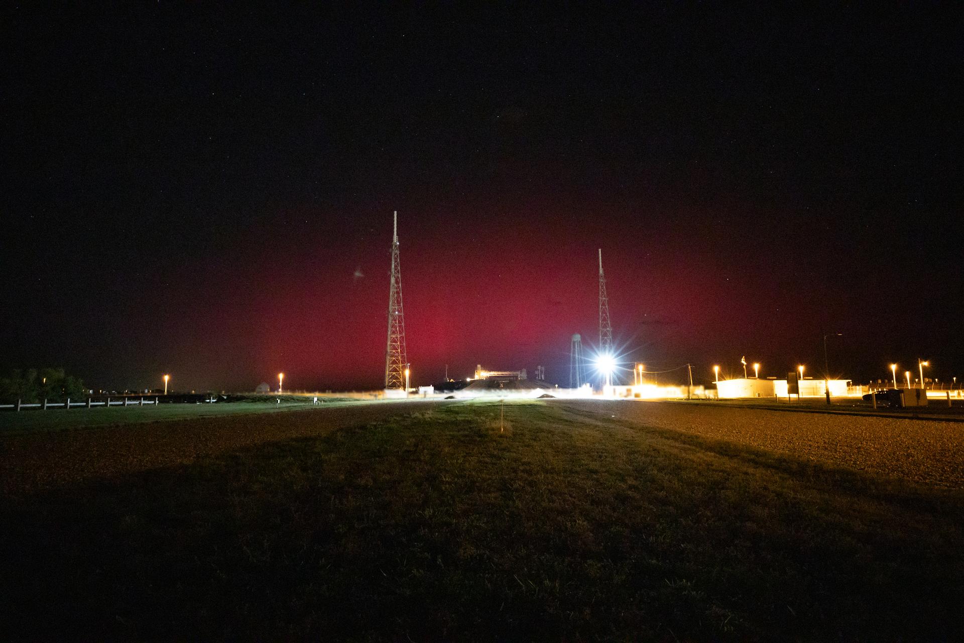 The faint glow of an aurora is seen over Launch Complex 39B at NASA’s Kennedy Space Center in Florida on Tuesday, Nov. 11, 2025. Auroras are created by energetic electrons, which rain down from Earth’s magnetic bubble and interact with particles in the upper atmosphere to create glowing lights that stretch across the sky.