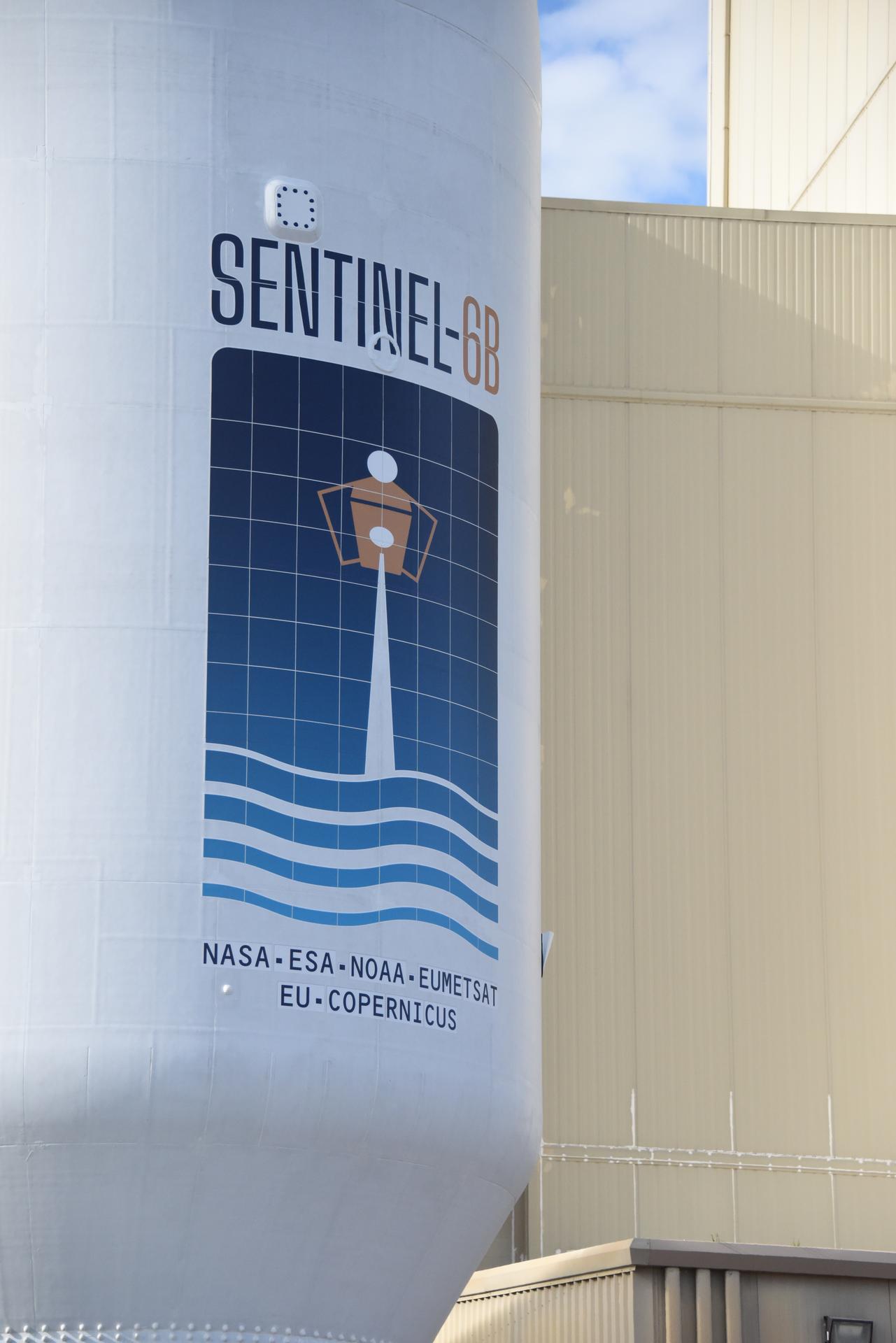 Workers transport the international Sentinel-6B satellite, encapsulated in the SpaceX Falcon 9 payload fairing, from the Astrotech Space Operations Facility to Space Launch Complex 4 East at Vandenberg Space Force Base in California on Wednesday, Nov. 12, 2025. A collaboration between NASA, ESA (European Space Agency), EUMETSAT (European Organisation for the Exploitation of Meteorological Satellites), and the National Oceanic and Atmospheric Administration (NOAA), Sentinel-6B is designed to measure sea levels down to roughly an inch for about 90% of the world’s oceans. NASA is targeting Sunday, Nov. 16, 2025, for launch.