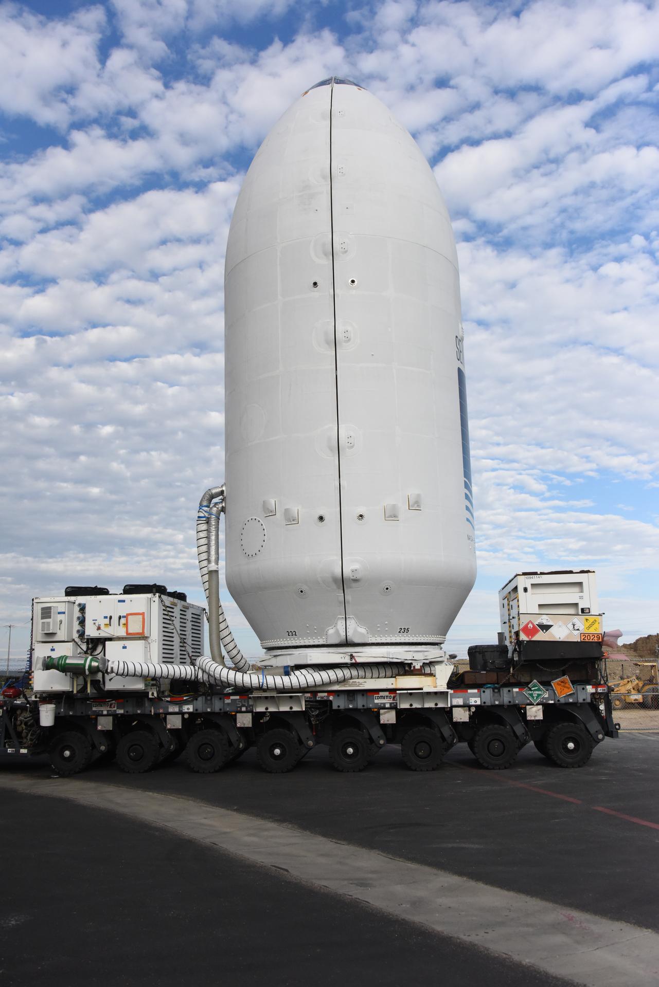 Workers transport the international Sentinel-6B satellite, encapsulated in the SpaceX Falcon 9 payload fairing, from the Astrotech Space Operations Facility to Space Launch Complex 4 East at Vandenberg Space Force Base in California on Wednesday, Nov. 12, 2025. A collaboration between NASA, ESA (European Space Agency), EUMETSAT (European Organisation for the Exploitation of Meteorological Satellites), and the National Oceanic and Atmospheric Administration (NOAA), Sentinel-6B is designed to measure sea levels down to roughly an inch for about 90% of the world’s oceans. NASA is targeting Sunday, Nov. 16, 2025, for launch.