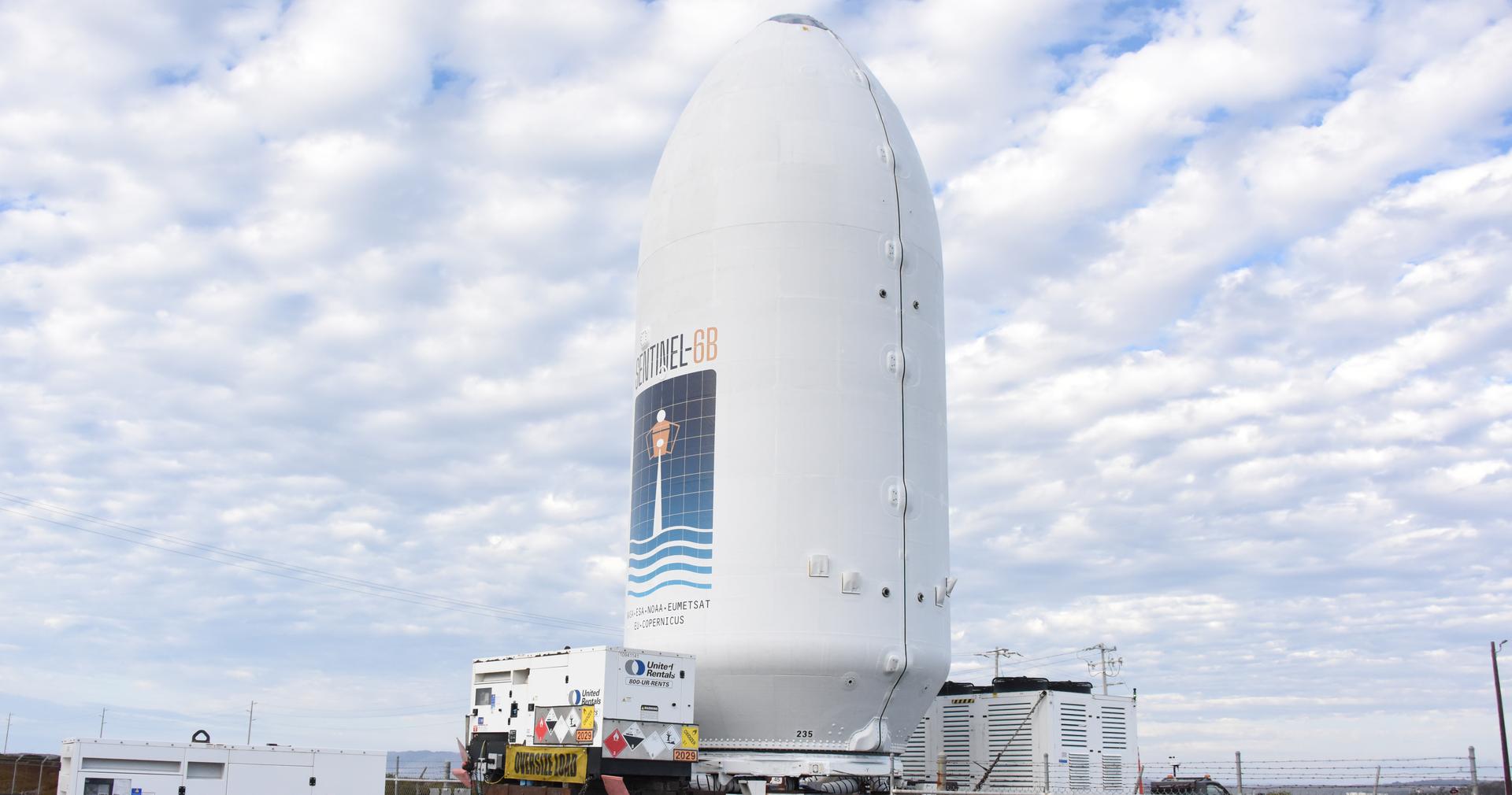 Workers transport the international Sentinel-6B satellite, encapsulated in the SpaceX Falcon 9 payload fairing, from the Astrotech Space Operations Facility to Space Launch Complex 4 East at Vandenberg Space Force Base in California on Wednesday, Nov. 12, 2025. A collaboration between NASA, ESA (European Space Agency), EUMETSAT (European Organisation for the Exploitation of Meteorological Satellites), and the National Oceanic and Atmospheric Administration (NOAA), Sentinel-6B is designed to measure sea levels down to roughly an inch for about 90% of the world’s oceans. NASA is targeting Sunday, Nov. 16, 2025, for launch.