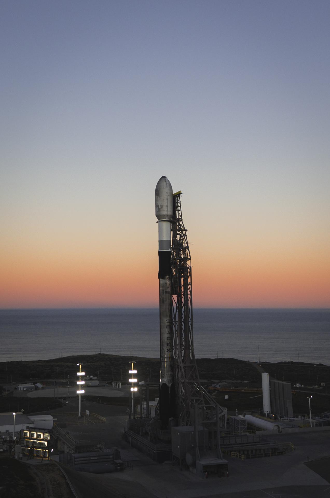 A SpaceX Falcon 9 rocket carrying NASA’s R5-S7 (Realizing Rapid, Reduced-cost high-Risk Research project Spacecraft 7) CubeSat along with several other satellites as part of the company’s Transporter-15 mission stands vertical on the launch pad of Space Launch Complex 4 East at Vandenberg Space Force Base in California on Wednesday, Nov. 26, 2025. The latest in a series of spacecraft, R5-S7 will explore ways to get multiple technology prototypes into low Earth orbit rapidly and at a low cost, accelerating the demonstration of these technologies in orbit and allowing engineers and scientists to more quickly prove them and make them available to NASA missions and other users.