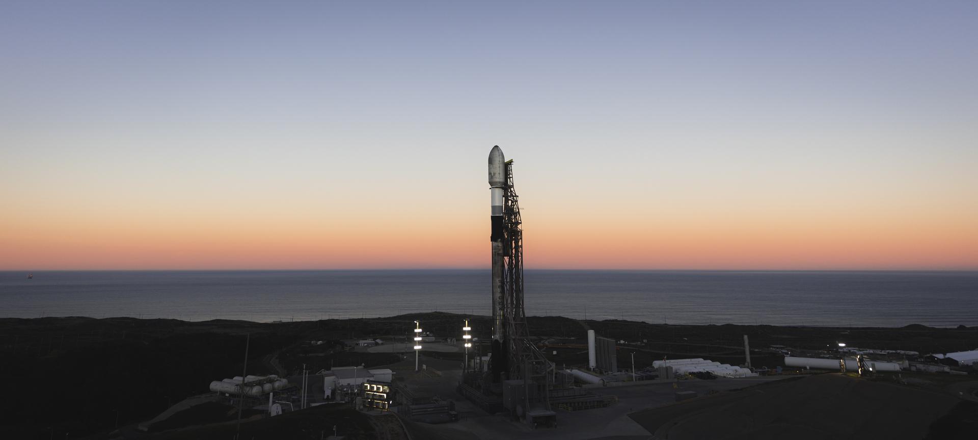 A SpaceX Falcon 9 rocket carrying NASA’s R5-S7 (Realizing Rapid, Reduced-cost high-Risk Research project Spacecraft 7) CubeSat along with several other satellites as part of the company’s Transporter-15 mission stands vertical on the launch pad of Space Launch Complex 4 East at Vandenberg Space Force Base in California on Wednesday, Nov. 26, 2025. The latest in a series of spacecraft, R5-S7 will explore ways to get multiple technology prototypes into low Earth orbit rapidly and at a low cost, accelerating the demonstration of these technologies in orbit and allowing engineers and scientists to more quickly prove them and make them available to NASA missions and other users.