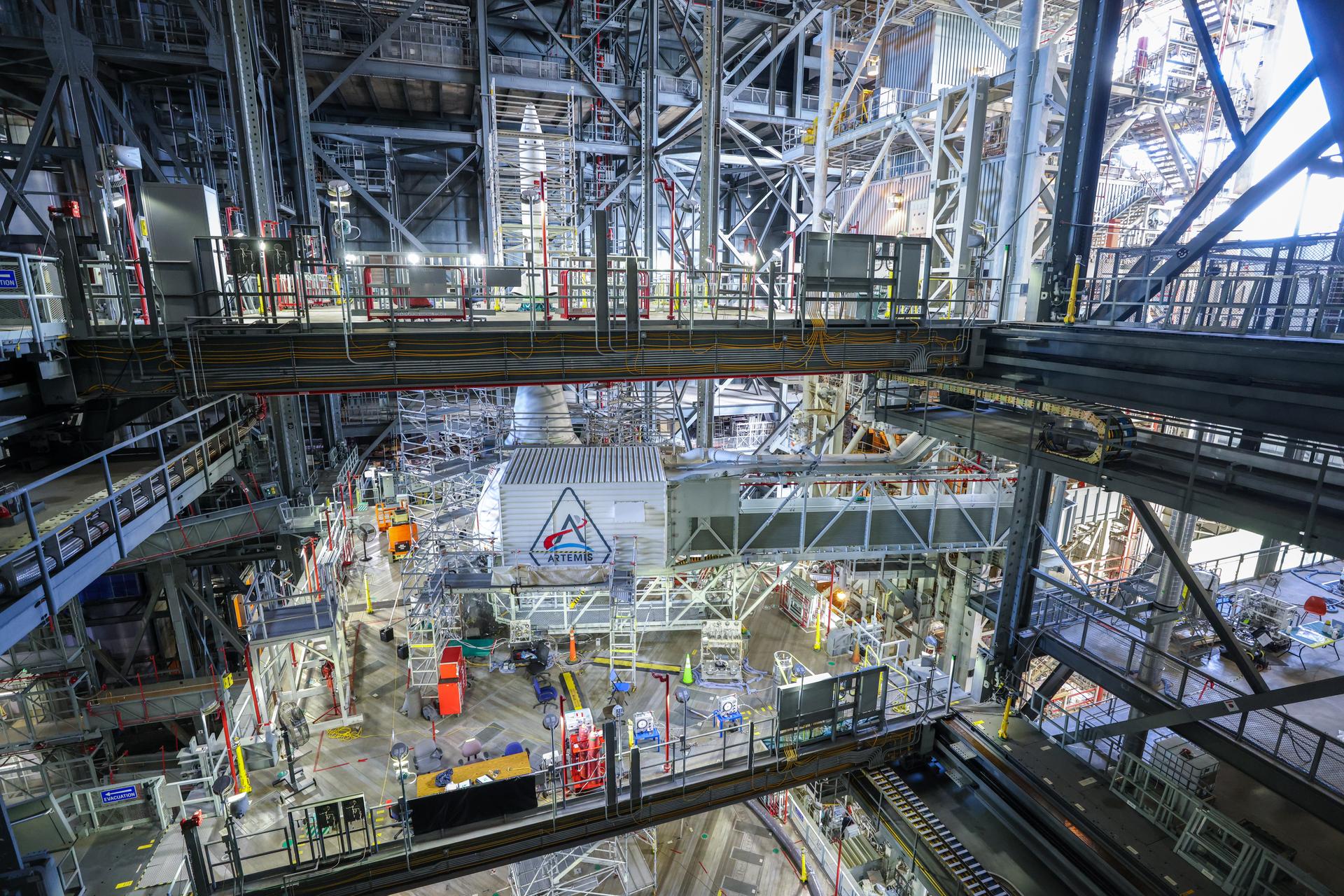 A freshly painted NASA’s Artemis logo is unveiled on the White Room connected to the crew access arm and mobile launcher inside the Vehicle Assembly Building at NASA’s Kennedy Space Center in Florida on Thursday, Dec. 4, 2025. The White Room is the area where the Artemis II crew Reid Wiseman, Victor Glover, Christina Koch, and CSA (Canadian Space Agency) astronaut Jeremy Hansen will enter the Orion spacecraft ahead of launch from Launch Complex 39B at NASA Kennedy in early 2026.