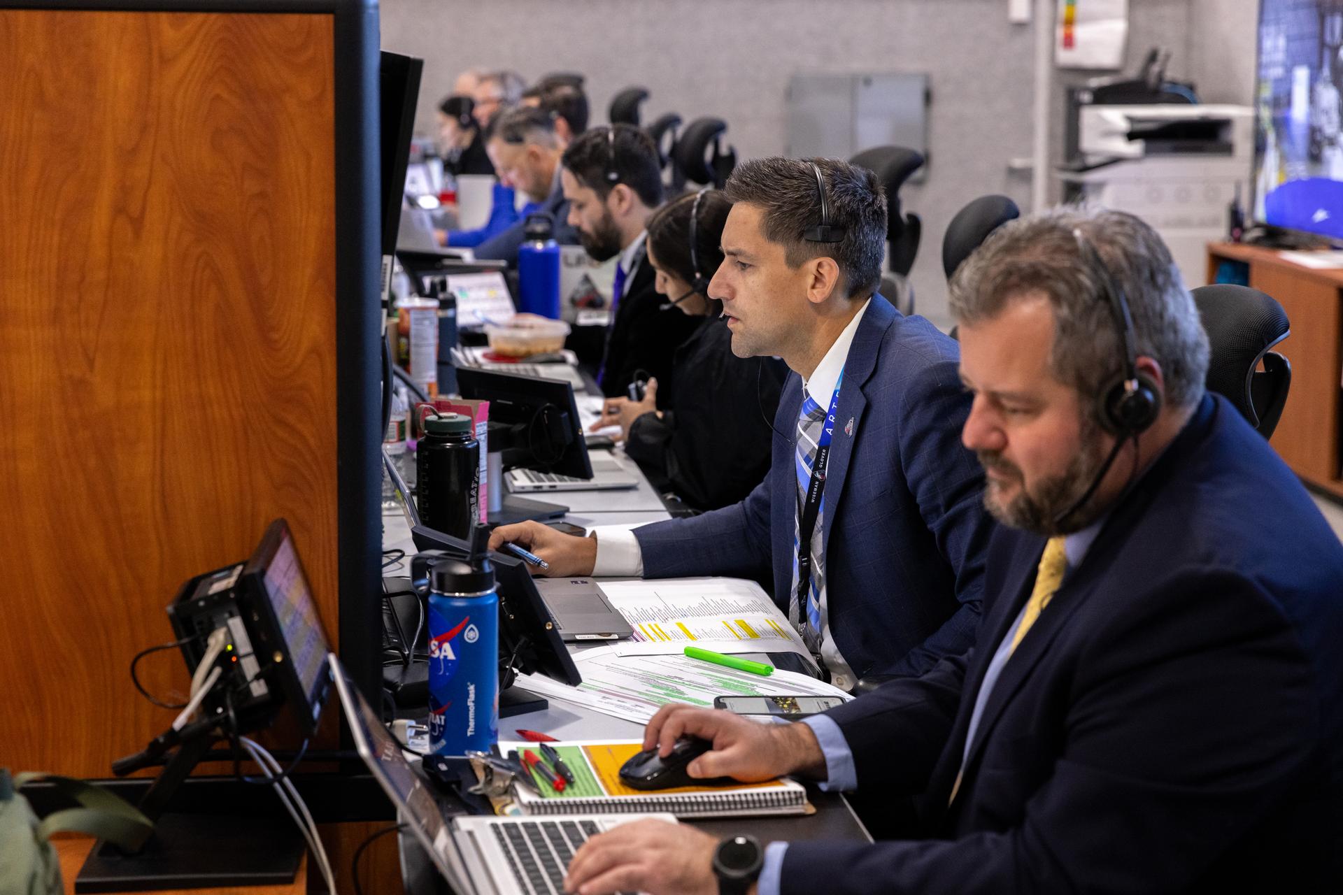 Dan Florez, NASA test director (second from right), monitors the progress of a countdown demonstration test with Artemis II crewmembers NASA astronauts Reid Wiseman, commander; Victor Glover, pilot; Christina Koch, mission specialist; and CSA (Canadian Space Agency) astronaut Jeremy Hansen, mission specialist onboard their Orion spacecraft from Firing Room 1 of the Rocco A. Petrone Launch Control Center, Saturday, Dec. 20, 2025, at NASA’s Kennedy Space Center in Florida. For this operation, the Artemis II crew and launch teams are simulating the launch day timeline including suit-up, walkout, and spacecraft ingress and egress. Through the Artemis campaign, NASA will send astronauts to explore the Moon for scientific discovery, economic benefits, and to build the foundation for the first crewed missions to Mars, for the benefit of all.