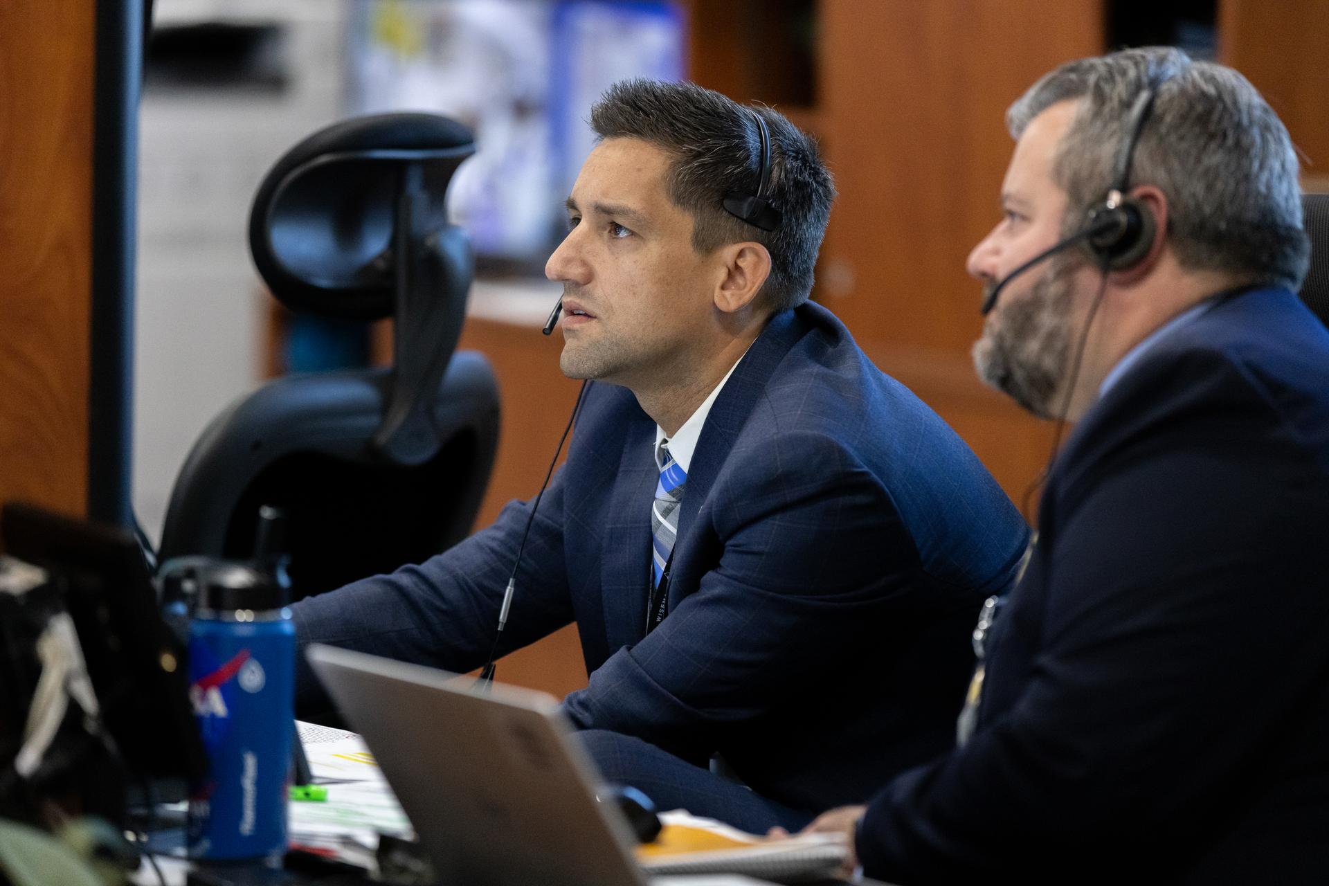 Dan Florez, NASA test director (second from right), monitors the progress of a countdown demonstration test with Artemis II crewmembers NASA astronauts Reid Wiseman, commander; Victor Glover, pilot; Christina Koch, mission specialist; and CSA (Canadian Space Agency) astronaut Jeremy Hansen, mission specialist onboard their Orion spacecraft from Firing Room 1 of the Rocco A. Petrone Launch Control Center, Saturday, Dec. 20, 2025, at NASA’s Kennedy Space Center in Florida. For this operation, the Artemis II crew and launch teams are simulating the launch day timeline including suit-up, walkout, and spacecraft ingress and egress. Through the Artemis campaign, NASA will send astronauts to explore the Moon for scientific discovery, economic benefits, and to build the foundation for the first crewed missions to Mars, for the benefit of all.