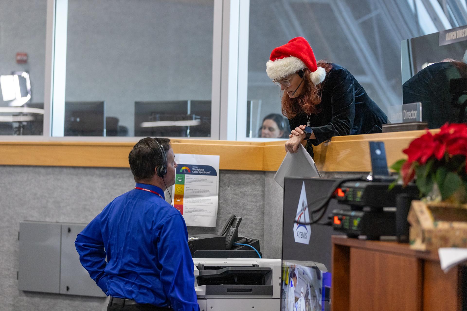 Charlie Blackwell-Thompson, Artemis launch director, talks to Wes Mondale, NASA test director, during a countdown demonstration test with Artemis II crewmembers NASA astronauts Reid Wiseman, commander; Victor Glover, pilot; Christina Koch, mission specialist; and CSA (Canadian Space Agency) astronaut Jeremy Hansen, mission specialist onboard their Orion spacecraft from Firing Room 1 of the Rocco A. Petrone Launch Control Center, Saturday, Dec. 20, 2025, at NASA’s Kennedy Space Center in Florida. For this operation, the Artemis II crew and launch teams are simulating the launch day timeline including suit-up, walkout, and spacecraft ingress and egress. Through the Artemis campaign, NASA will send astronauts to explore the Moon for scientific discovery, economic benefits, and to build the foundation for the first crewed missions to Mars, for the benefit of all.
