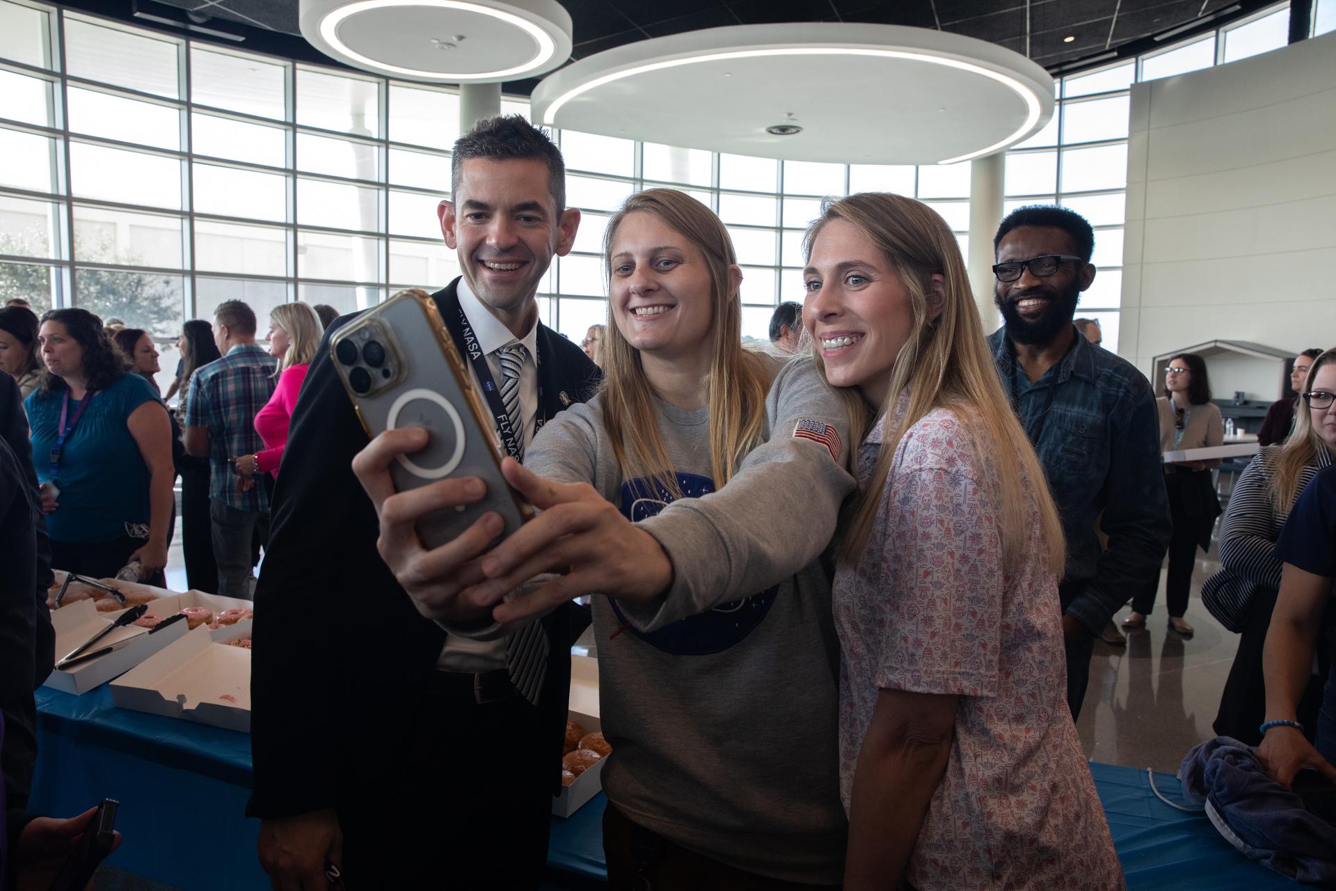 NASA Administrator Jared Isaacman (left) poses for a selfie with NASA employees during his visit to NASA’s Kennedy Space Center in Florida, on Tuesday, Jan. 13, 2026. Isaacman, NASA’s 15th administrator, began visiting the agency’s centers after his appointment on Dec. 17, 2025, to hear from employees, contractors, and partners.