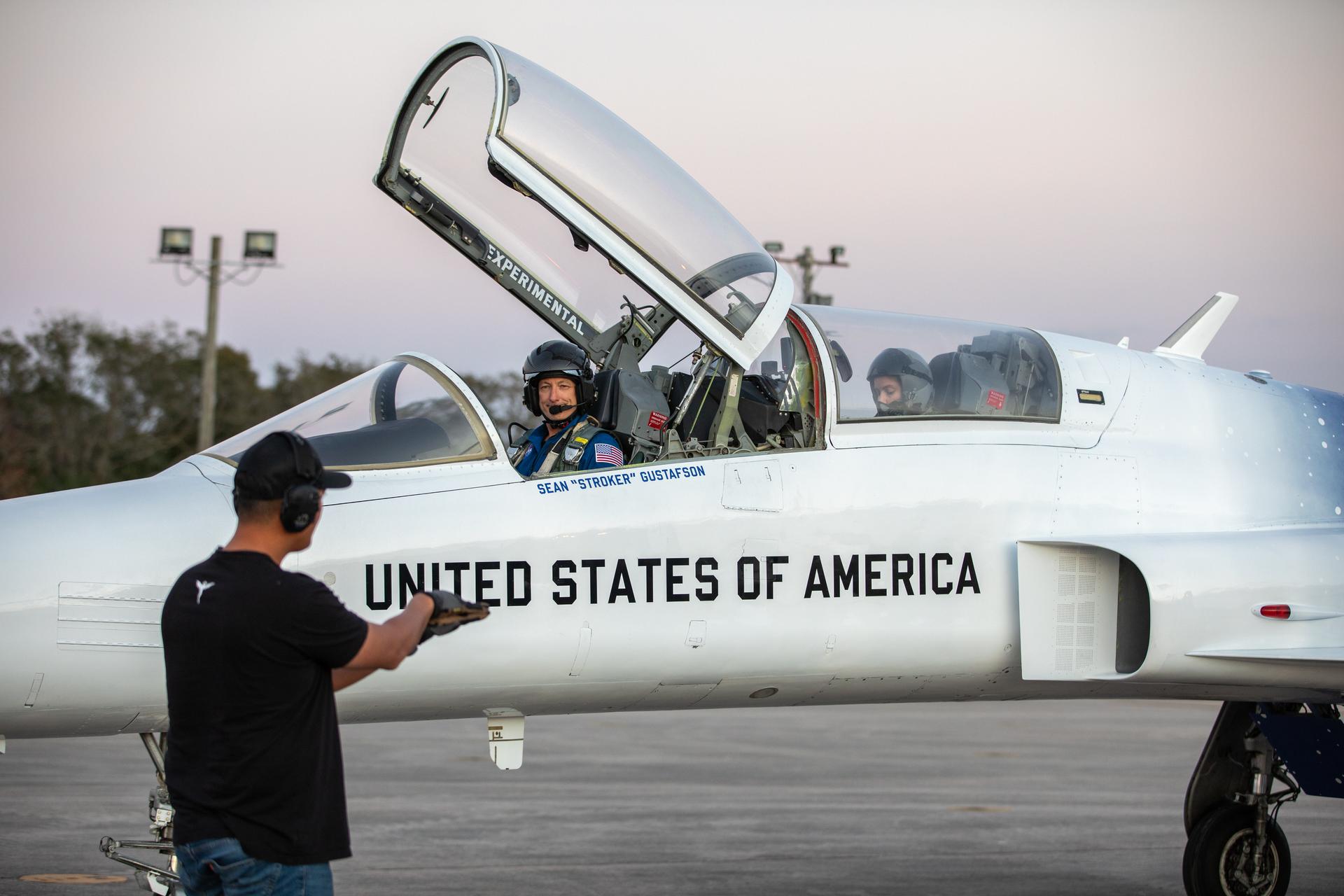 From left, Sean “Stroker” Gustafson, pilot, and Ashley Scharfenberg, Systems Engineering and Integration for Exploration Ground Systems, prepares for her employee incentive flight around NASA’s Kennedy Space Center in Florida on Tuesday, Jan. 13, 2026. As the newly appointed 15th administrator of the agency, Jared Isaacman created a ride-along program to recognize and reward members of the workforce for their dedication to accomplishing agency priorities. Scharfenberg, and Daniel Forrestel, manager, Ground and Missions Operations Office, (not pictured), were the first two employees to be recognized in the ride-along program to fly in Isaacman’s personal Northrop F-5 Tiger II aircraft. 
