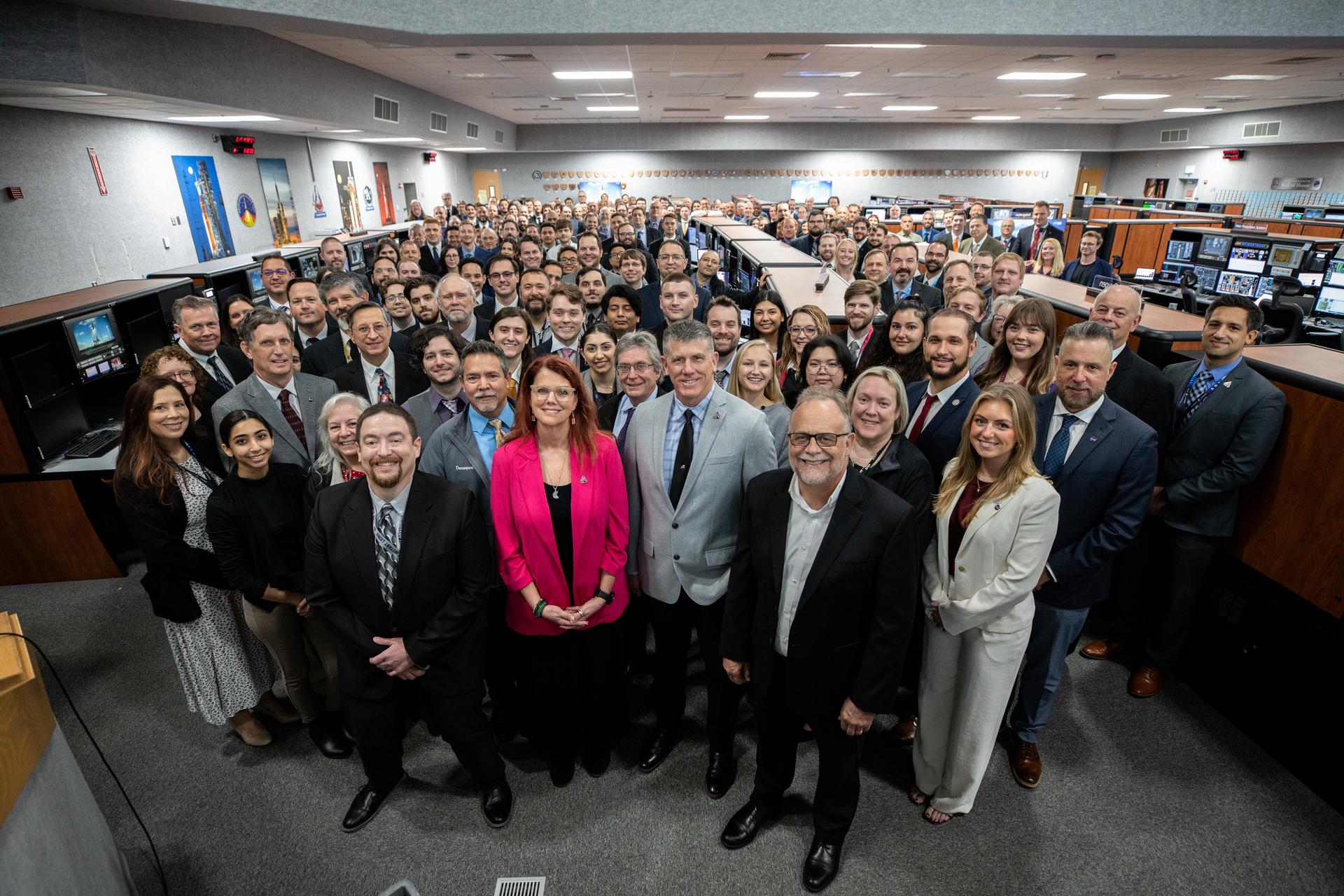 Members of NASA’s Exploration Ground Systems team pose for a photograph following the completion of the Artemis II terminal count simulation on Wednesday, Jan. 14, 2026, inside Firing Room 1 of the Rocco A. Petrone Launch Control Center at NASA’s Kennedy Space Center in Florida. The terminal count simulation conducted by NASA’s Exploration Ground Systems team runs through the final five hours of launch countdown, include terminal count - the remaining 10 minutes of the countdown - for NASA’s Artemis II test flight which will take Commander Reid Wiseman, Pilot Victor Glover, and Mission Specialist Christina Koch from NASA, and Mission Specialist Jeremy Hansen from the CSA (Canadian Space Agency), around the Moon and back to Earth no later than no later than April 2026 from Launch Complex 39B at NASA Kennedy.