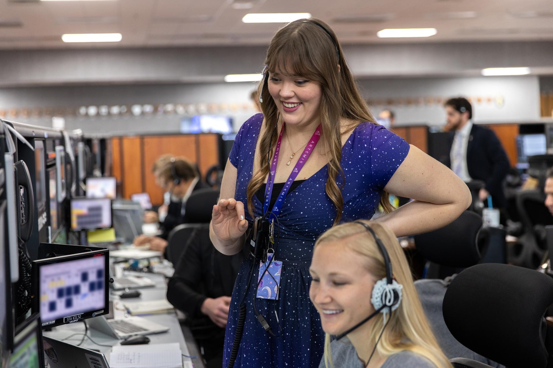 From left to right, Artemis launch team members Emily Eilish, Clare Hadley, and Holly Wells participate in the Artemis II terminal count simulation on Wednesday, Jan. 14, 2026, inside Firing Room 1 of the Rocco A. Petrone Launch Control Center at NASA’s Kennedy Space Center in Florida. The terminal count simulation conducted by NASA’s Exploration Ground Systems team runs through the final five hours of launch countdown, include terminal count - the remaining 10 minutes of the countdown - for NASA’s Artemis II test flight which will take Commander Reid Wiseman, Pilot Victor Glover, and Mission Specialist Christina Koch from NASA, and Mission Specialist Jeremy Hansen from the CSA (Canadian Space Agency), around the Moon and back to Earth no later than no later than April 2026 from Launch Complex 39B at NASA Kennedy.
