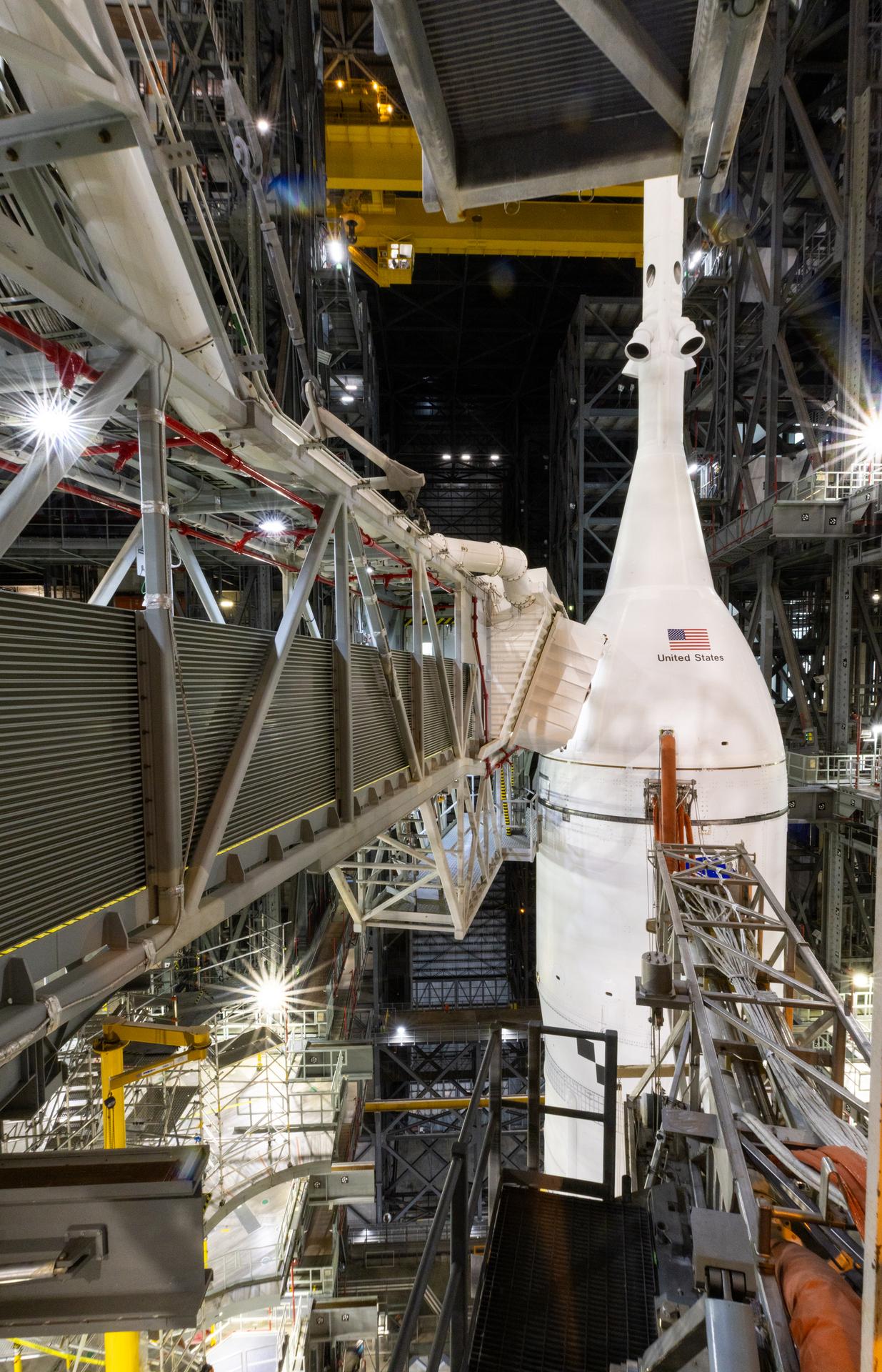 This close up of the crew access arm shows all work platforms retracted from around NASA’s Artemis II SLS (Space Launch System) rocket and Orion spacecraft, secured to the mobile launcher, inside the Vehicle Assembly Building on Saturday, Jan. 17, 2026, in preparation for rollout to Launch Complex 39B at NASA’s Kennedy Space Center in Florida. NASA’s Artemis II flight test will take Commander Reid Wiseman, Pilot Victor Glover, and Mission Specialist Christina Koch from NASA, and Mission Specialist Jeremy Hansen from the CSA (Canadian Space Agency), around the Moon and back to Earth no later than no later than April 2026.