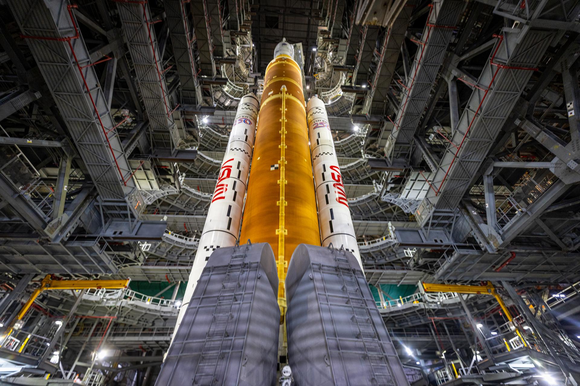 In this view looking up inside the Vehicle Assembly Building on Saturday, Jan. 17, 2026, the work platforms are retracted around NASA’s Artemis II SLS (Space Launch System) rocket and Orion spacecraft in preparation for rollout to Launch Complex 39B at NASA’s Kennedy Space Center in Florida. NASA’s Artemis II flight test will take Commander Reid Wiseman, Pilot Victor Glover, and Mission Specialist Christina Koch from NASA, and Mission Specialist Jeremy Hansen from the CSA (Canadian Space Agency), around the Moon and back to Earth no later than no later than April 2026.